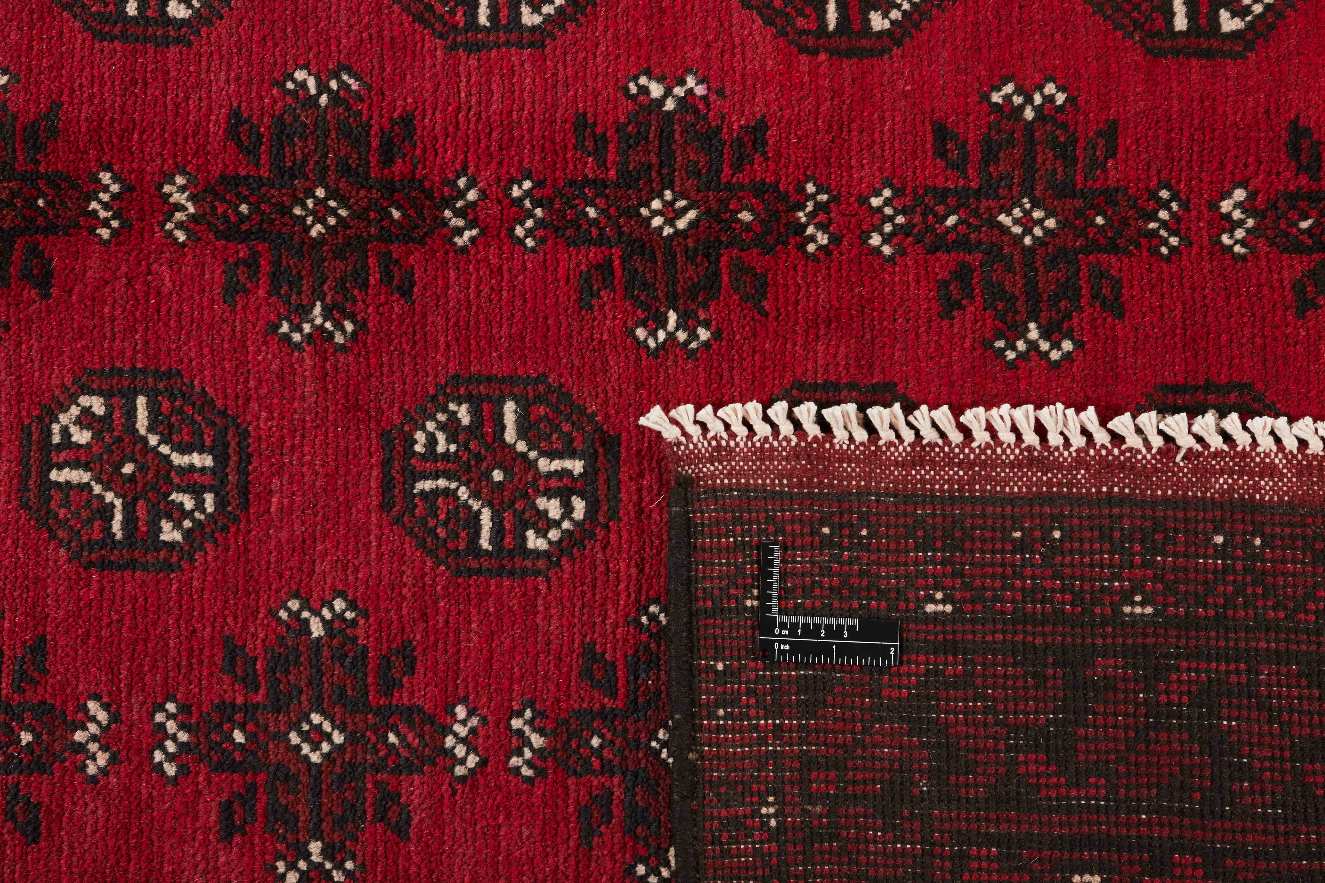 Red oriental rug with traditional elephant's foot pattern