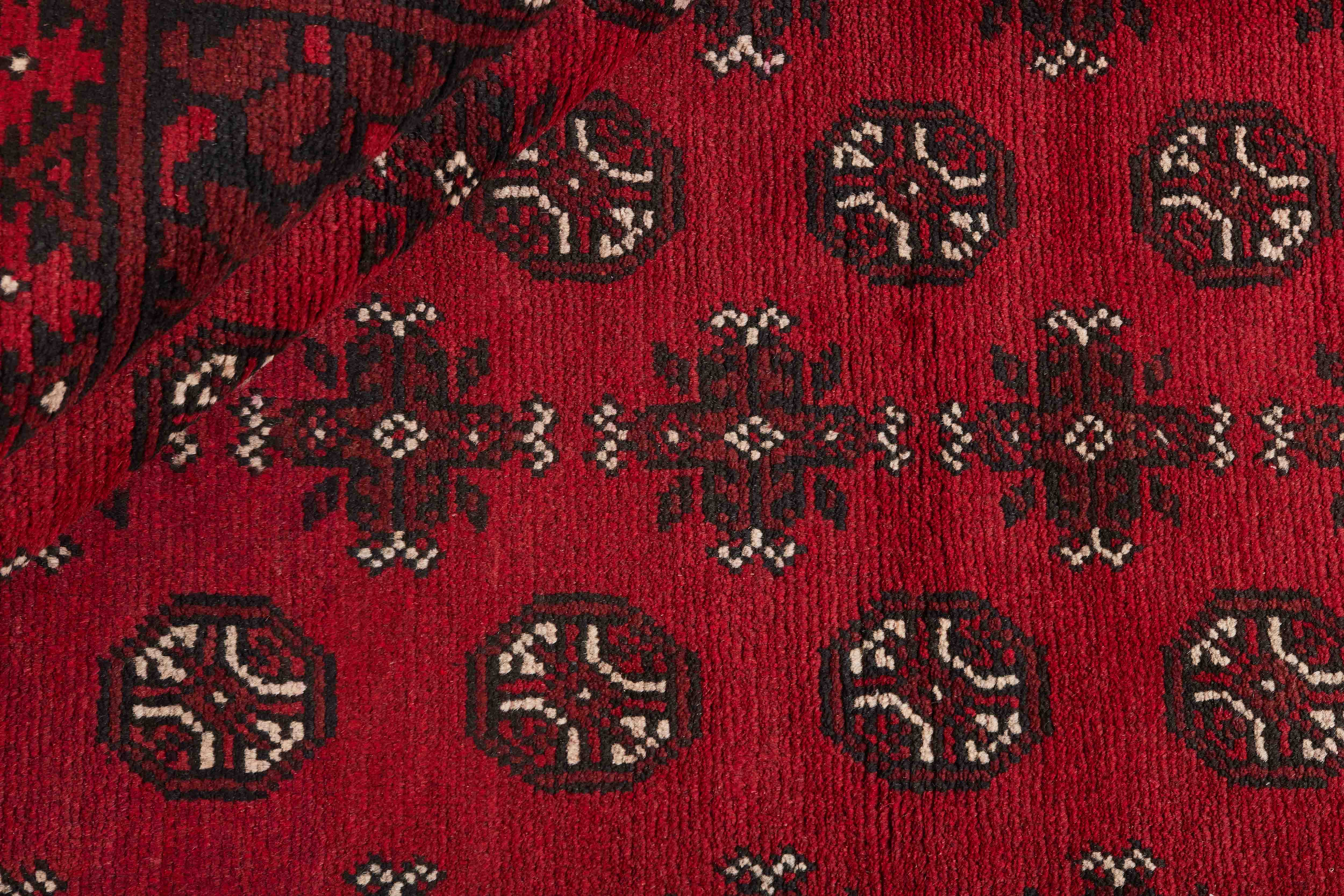 Red oriental rug with traditional elephant's foot pattern