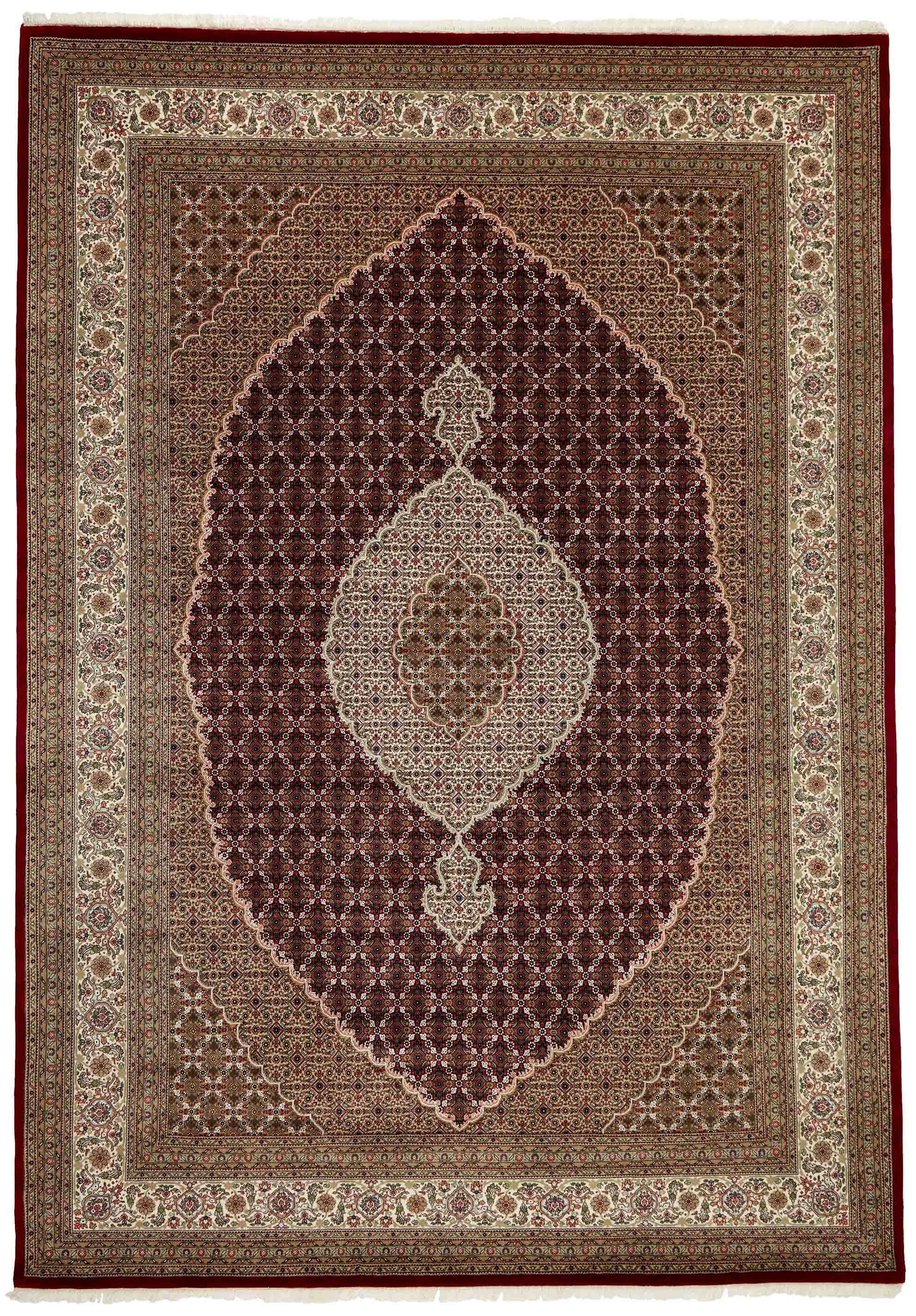 Authentic Oriental rug with traditional geometric and floral design in red, blue, green, beige, brown and black