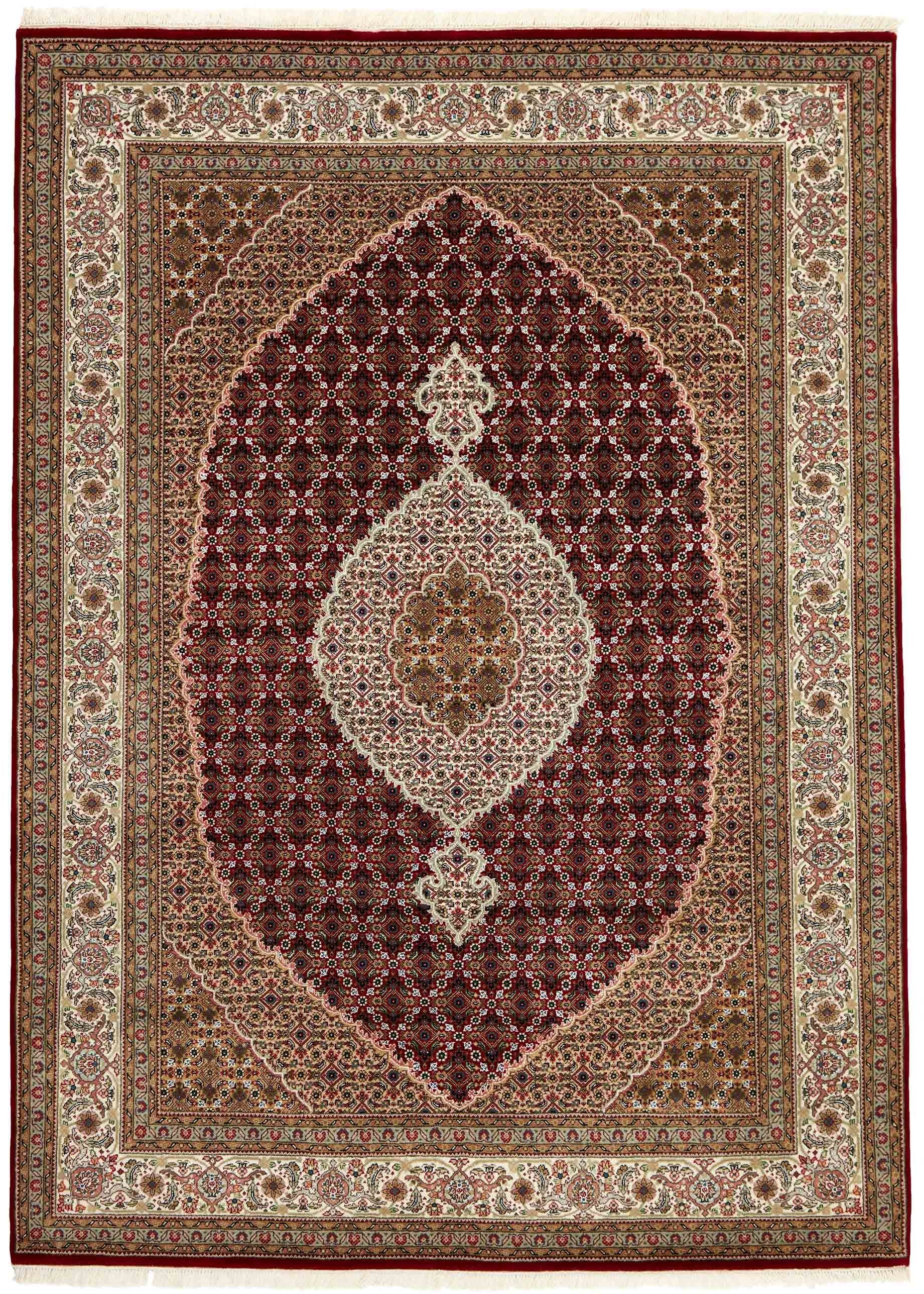 Authentic Oriental rug with traditional geometric and floral design in red, blue, green, beige, brown and black