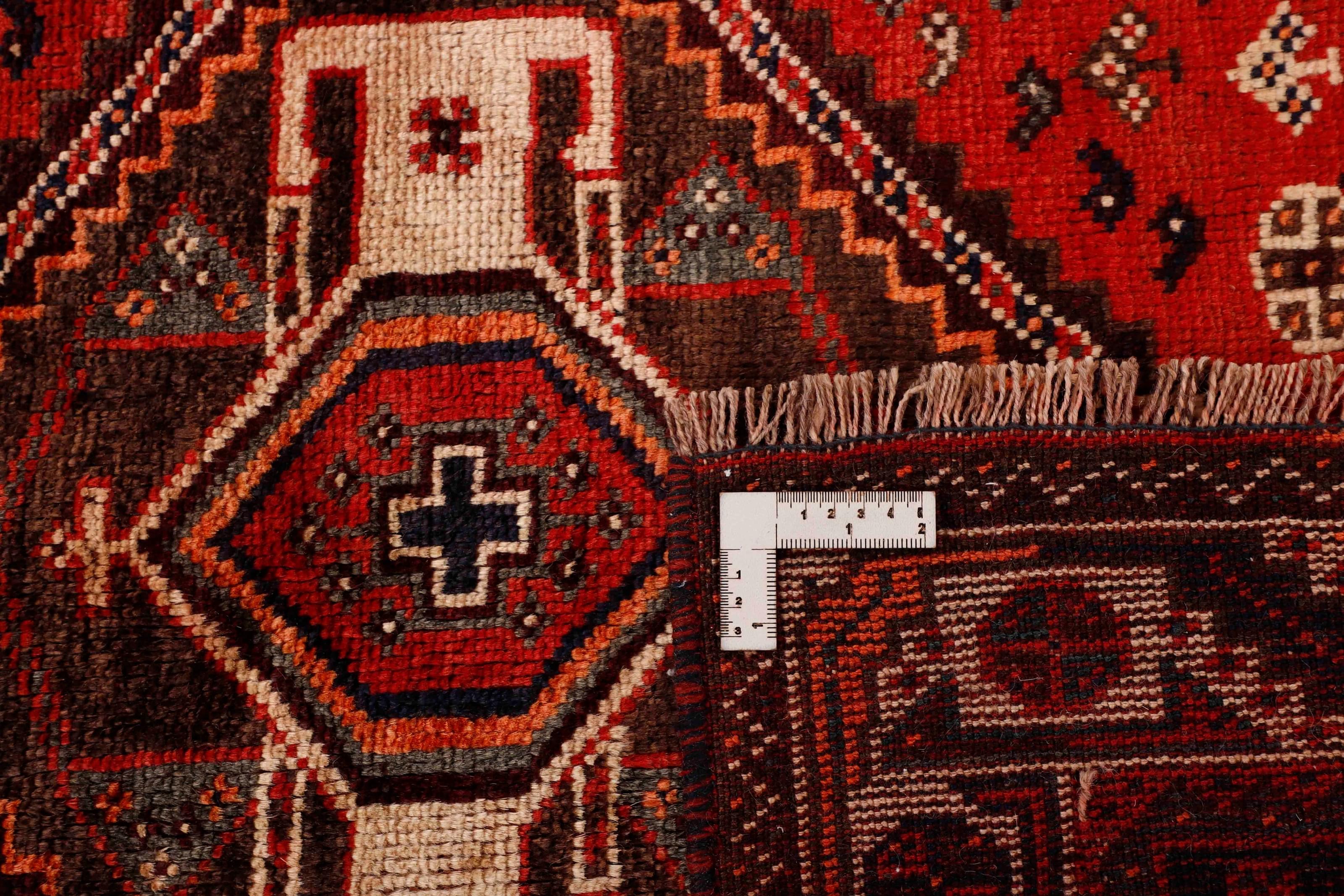 Authentic persian rug with a traditional tribal geometric pattern in red