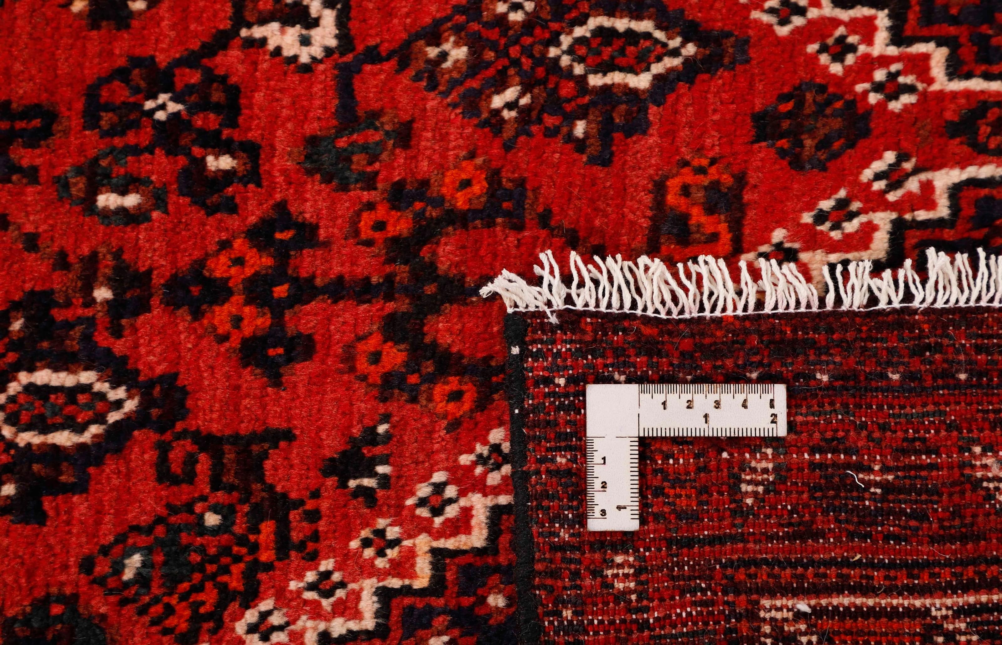 Authentic persian rug with a traditional tribal geometric pattern in red