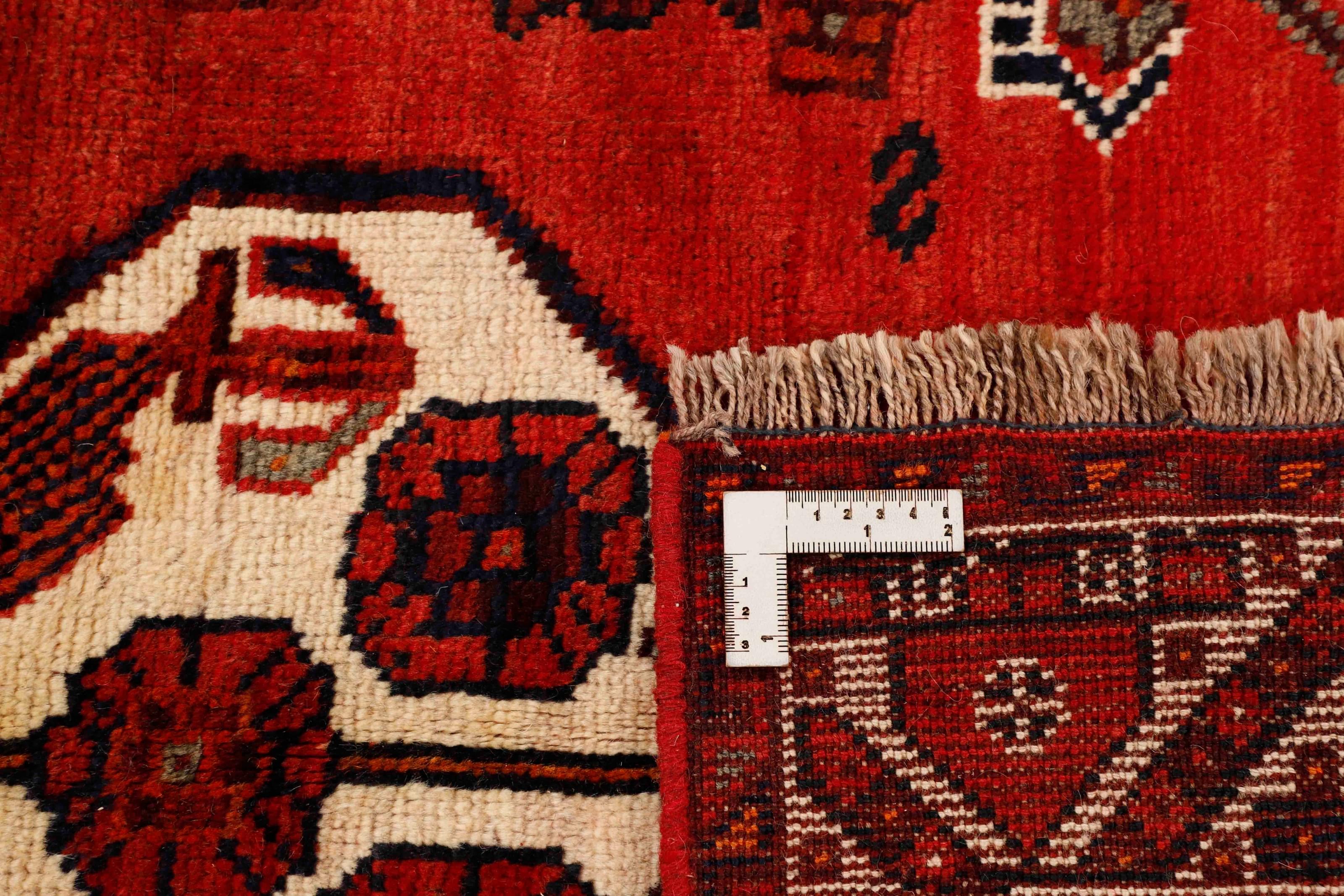 Authentic persian rug with a traditional tribal geometric pattern in red