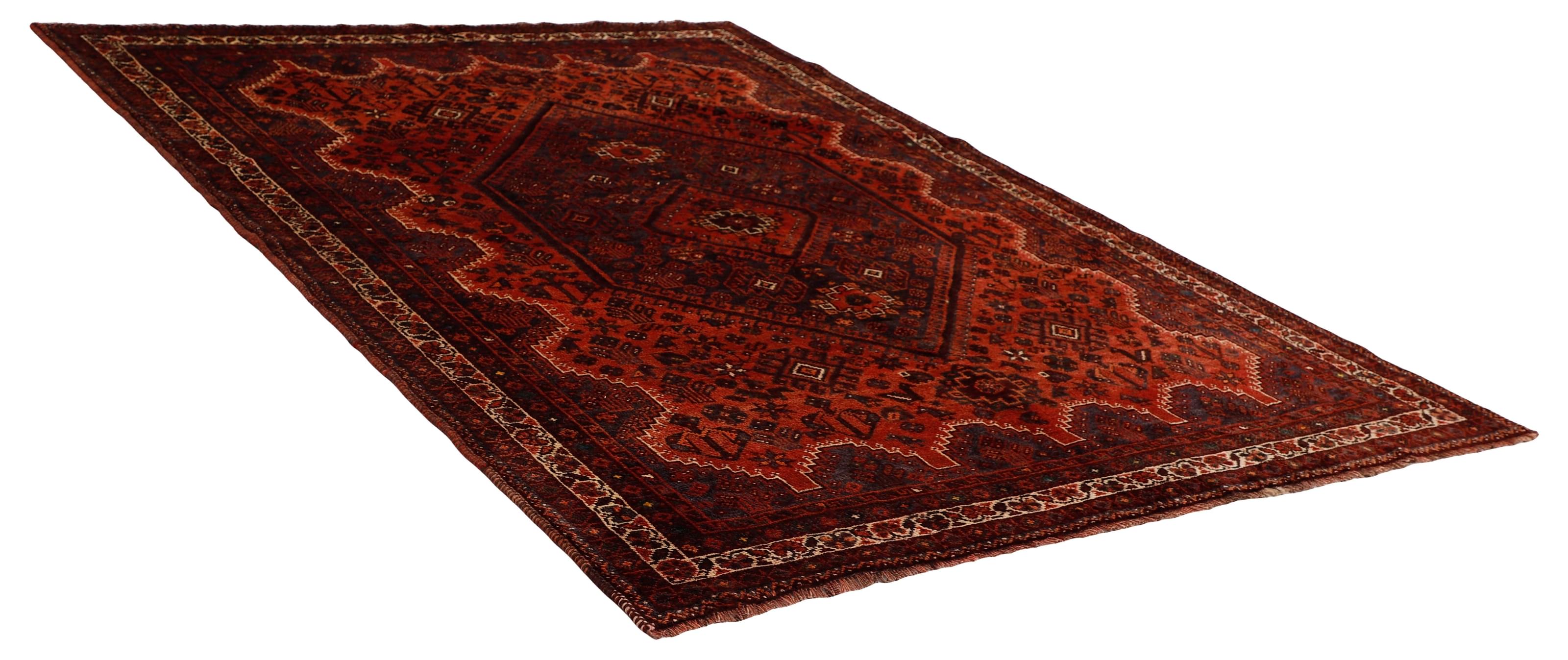 Authentic persian rug with a traditional tribal geometric pattern in red
