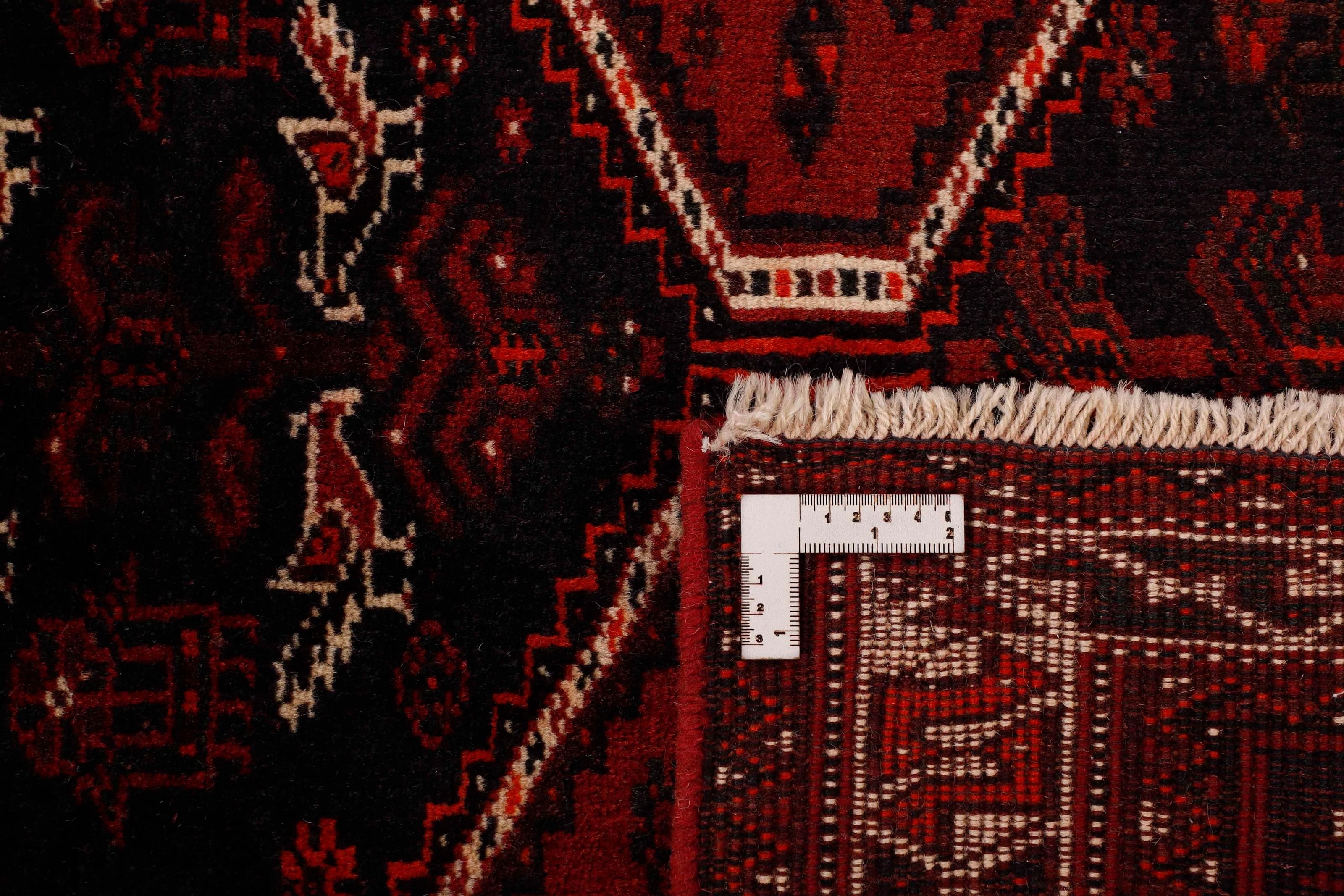 Authentic persian rug with a traditional tribal geometric pattern in red