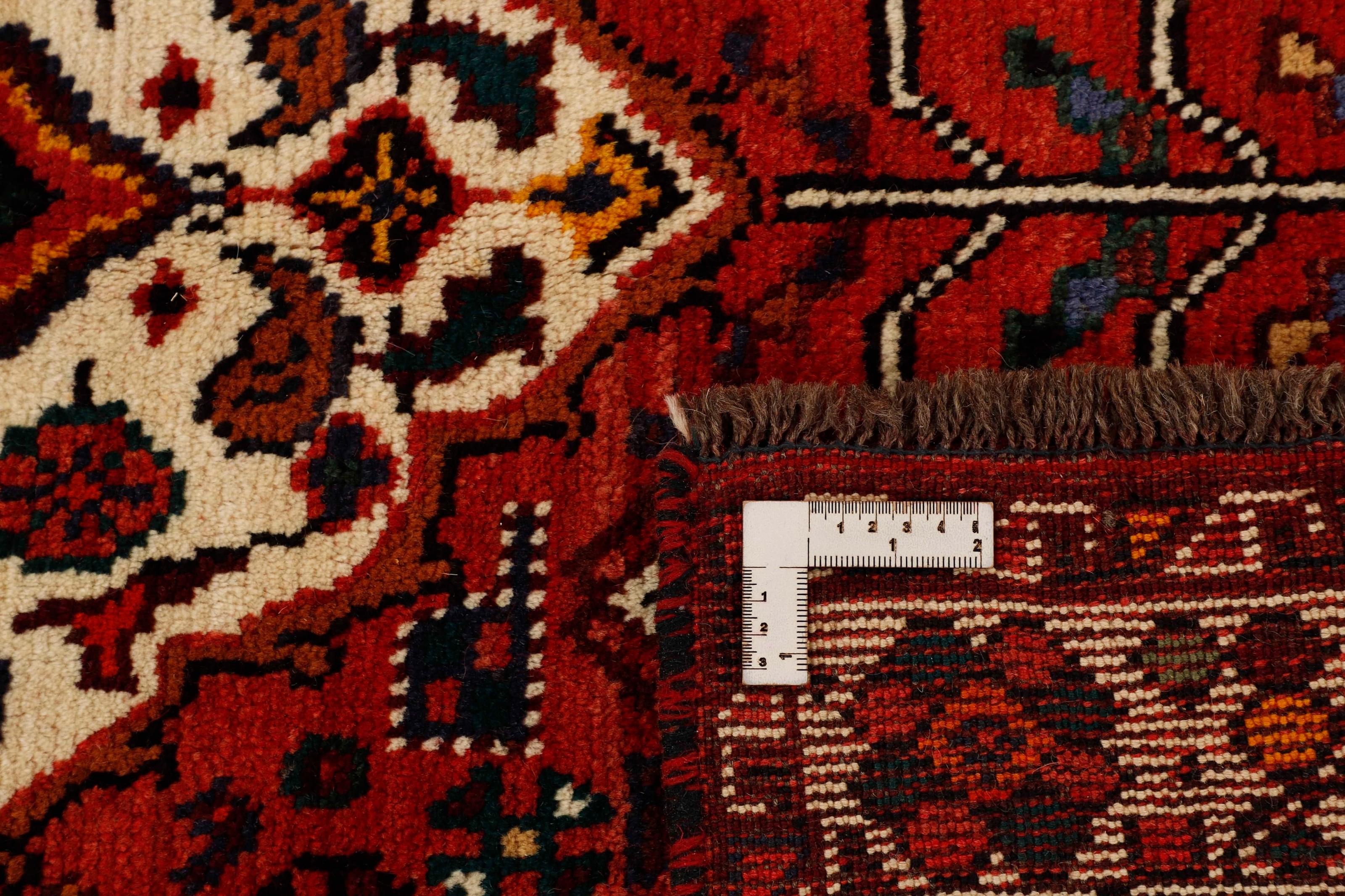 Authentic persian rug with a traditional tribal geometric pattern in red