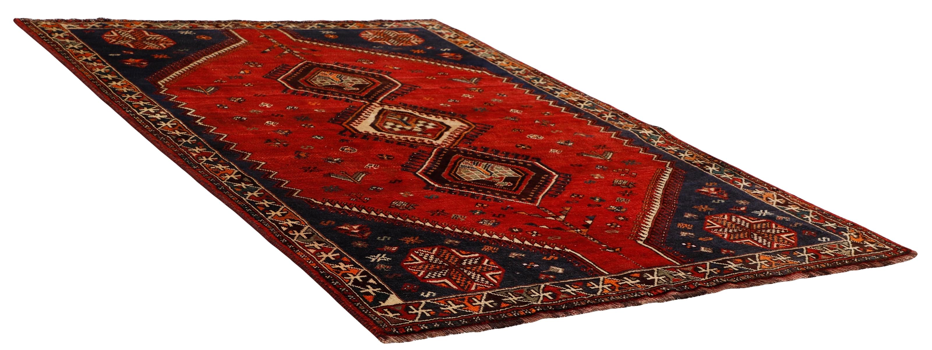 Authentic persian rug with a traditional tribal geometric pattern in red