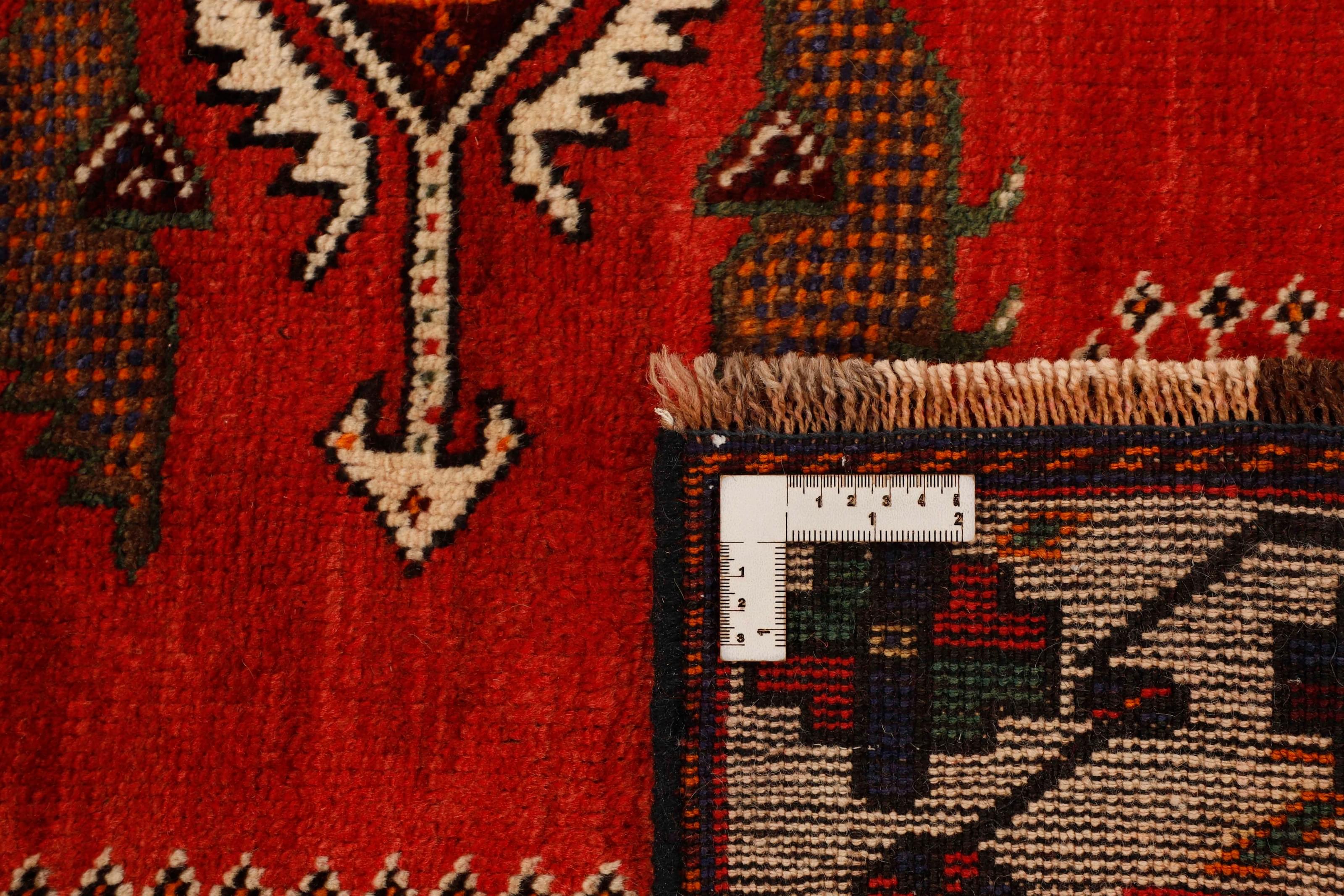 Authentic persian rug with a traditional tribal geometric pattern in red