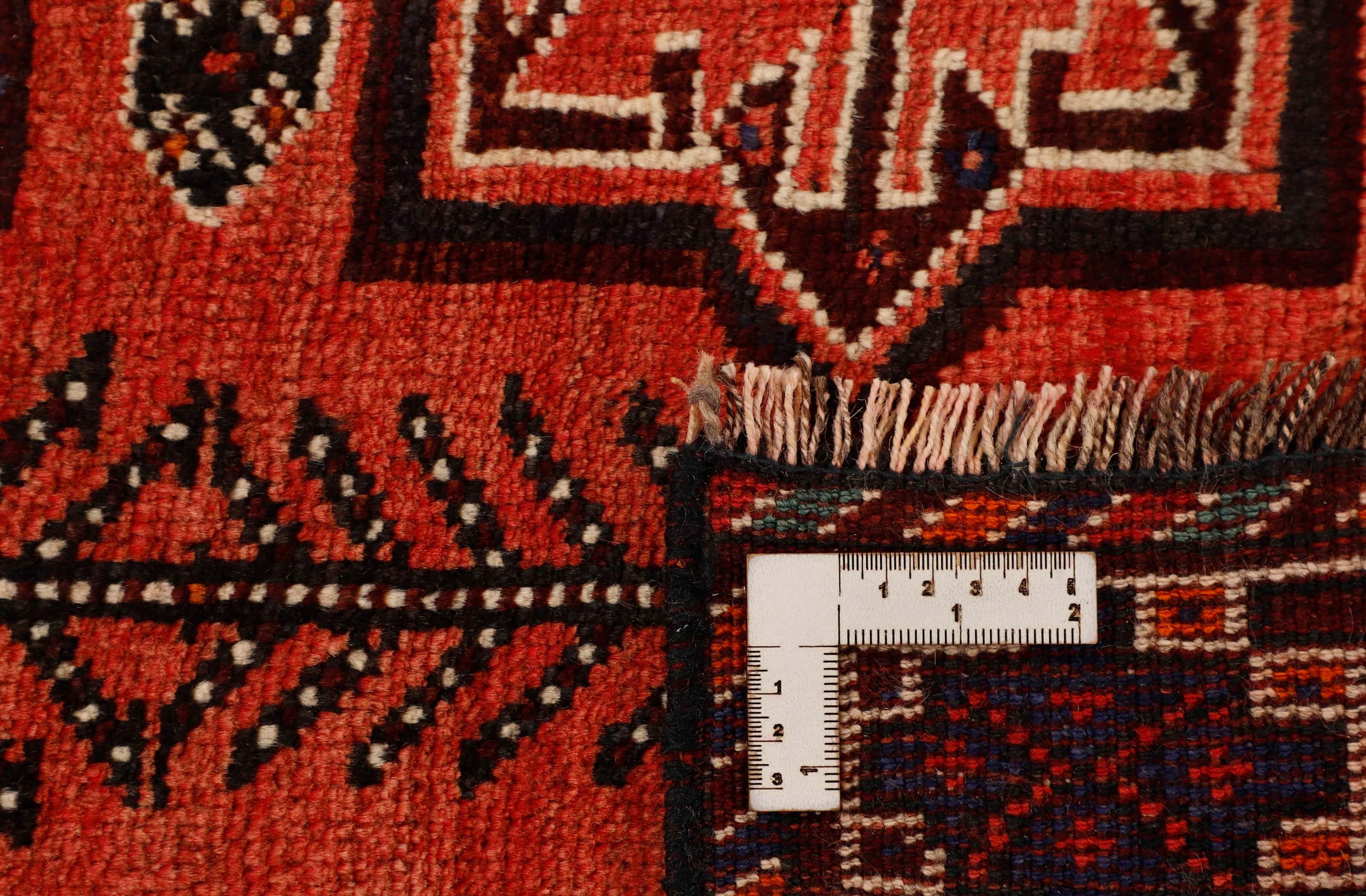 Authentic persian rug with a traditional tribal geometric pattern in red