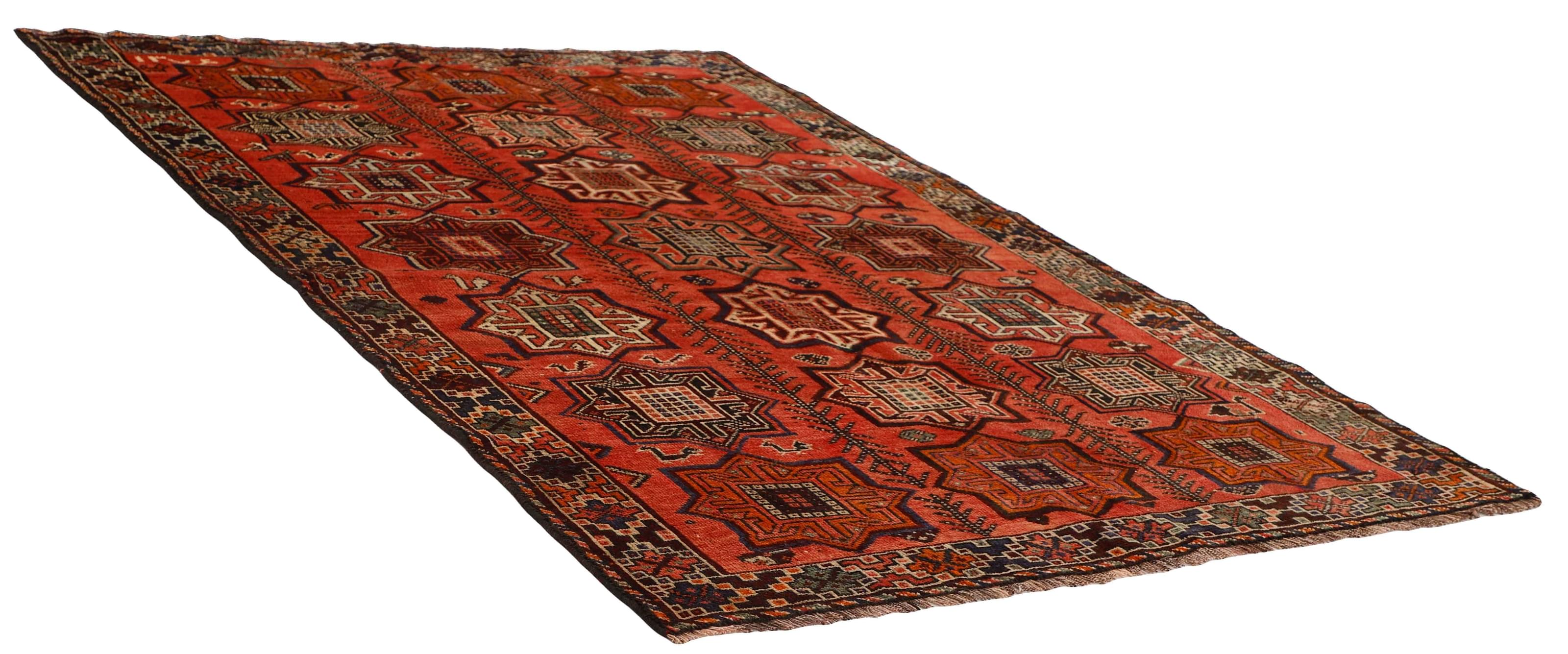 Authentic persian rug with a traditional tribal geometric pattern in red