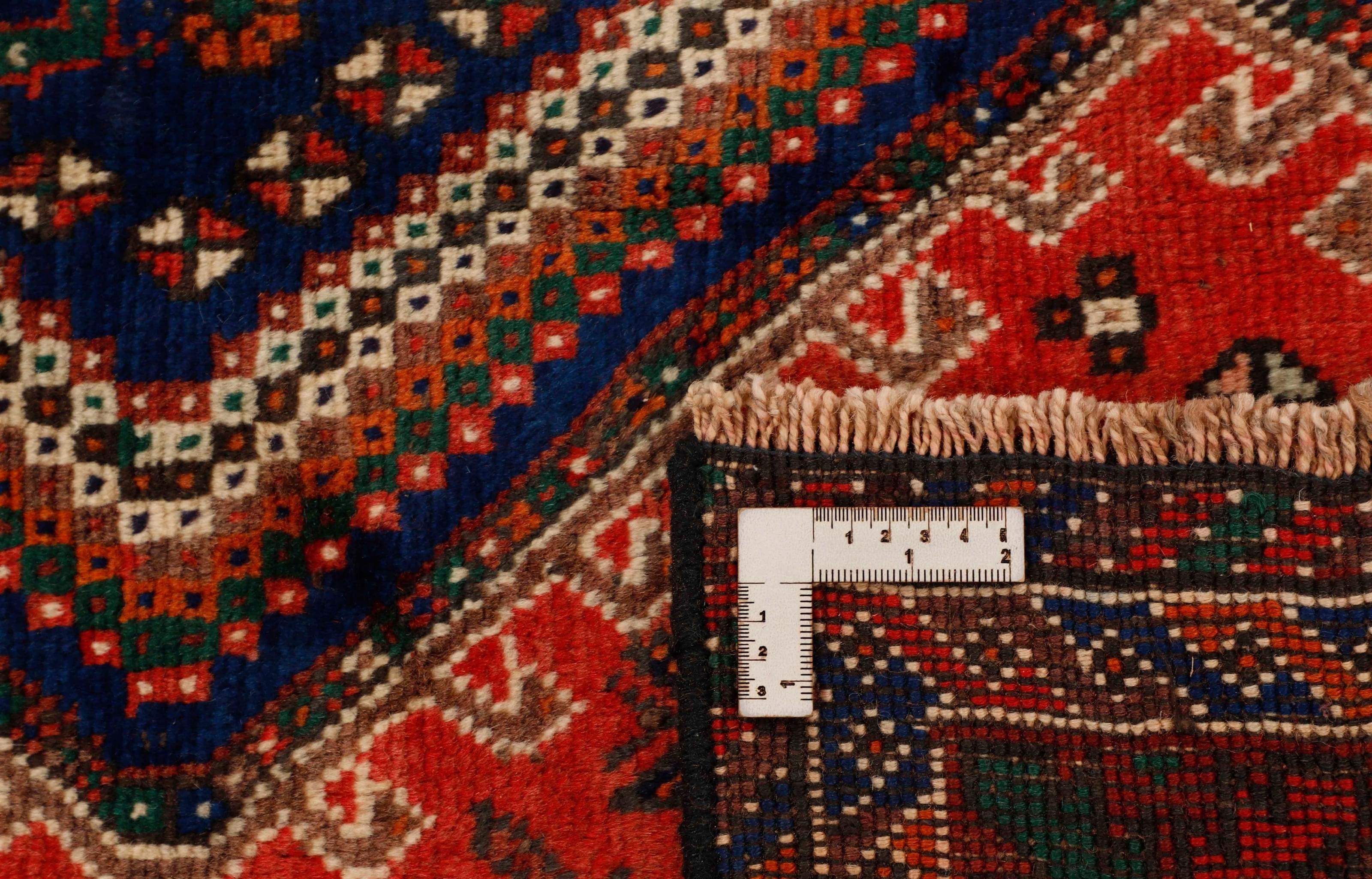Authentic persian rug with a traditional tribal geometric pattern in red