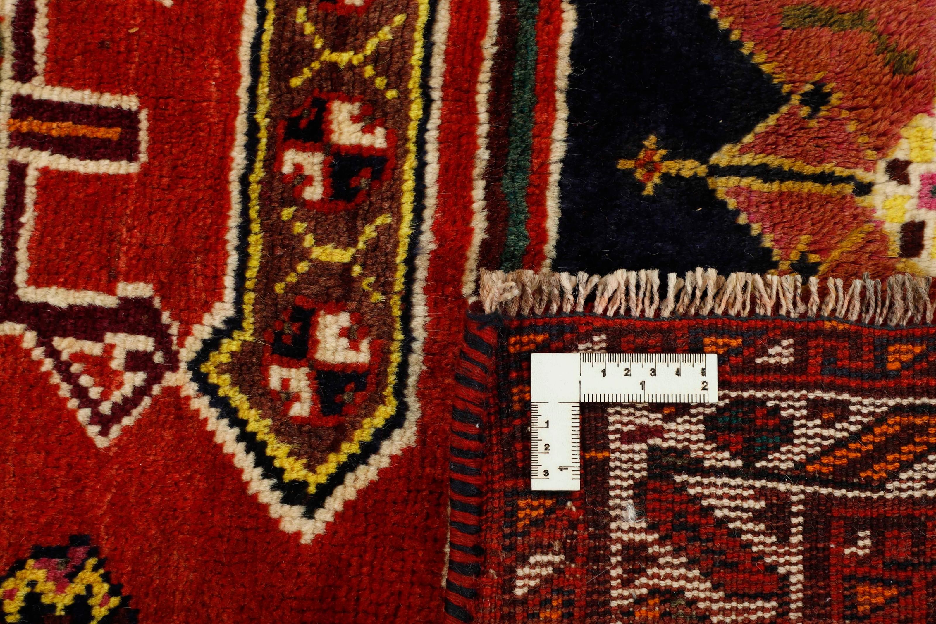 Authentic persian rug with a traditional tribal geometric pattern in red
