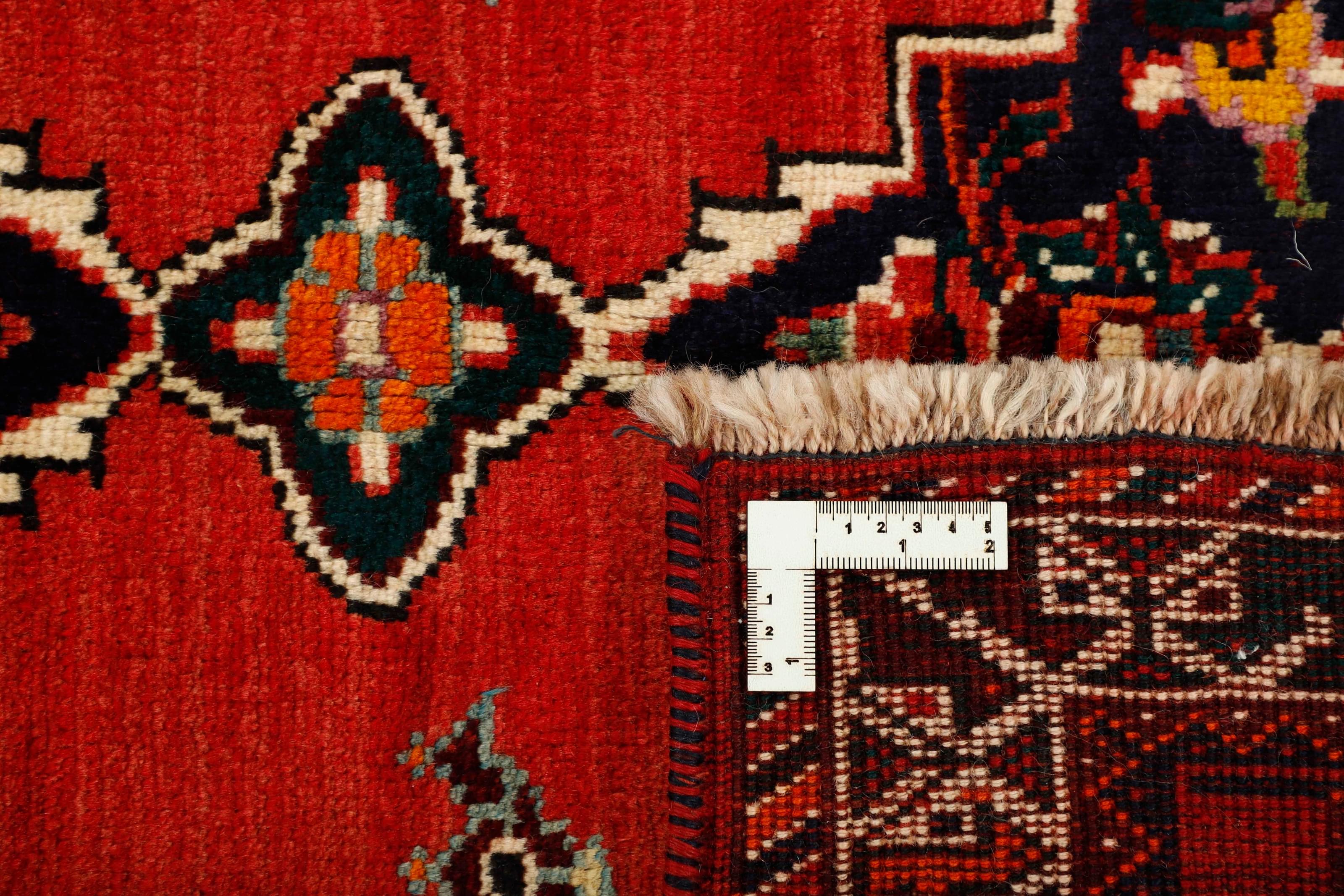 Authentic persian rug with a traditional tribal geometric pattern in red
