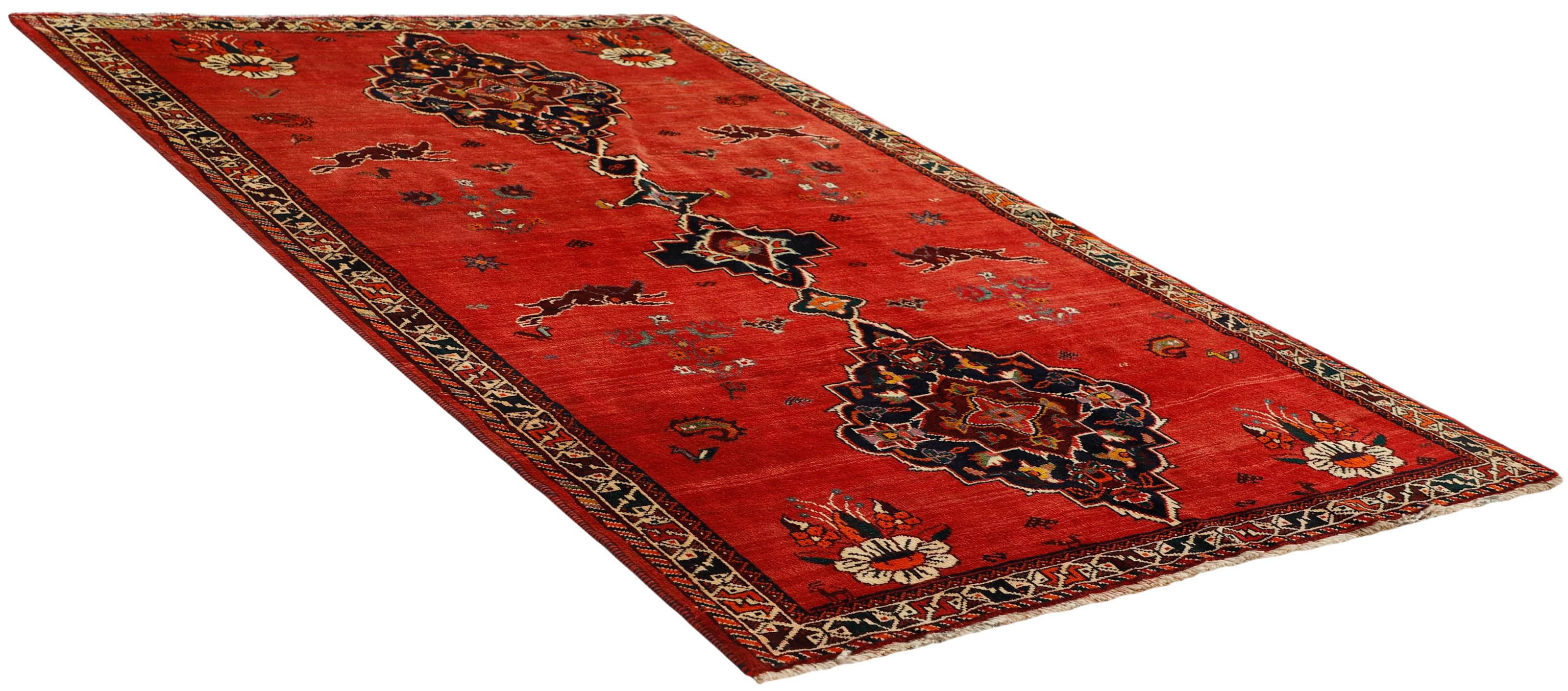 Authentic persian rug with a traditional tribal geometric pattern in red