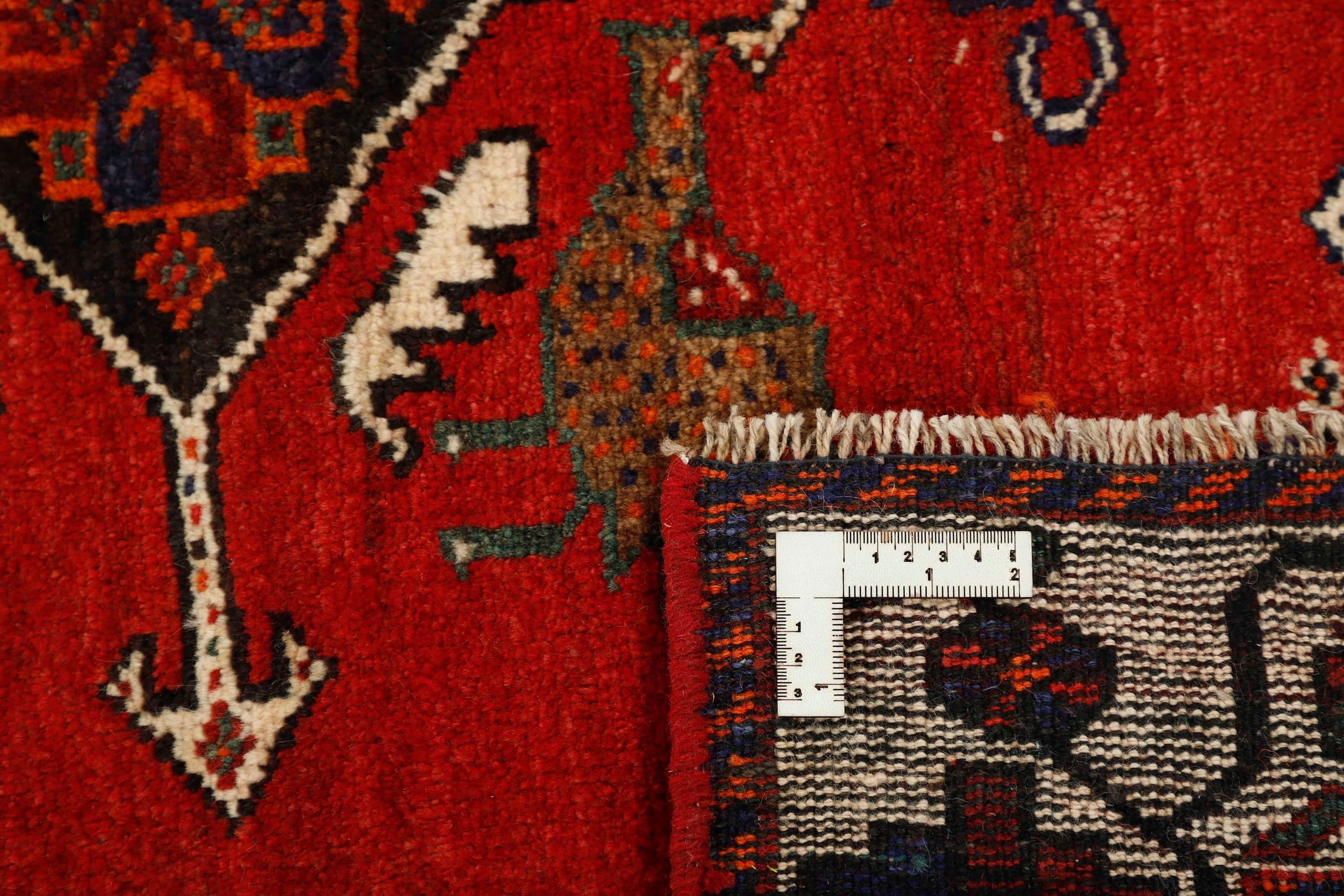 Authentic persian rug with a traditional tribal geometric pattern in red