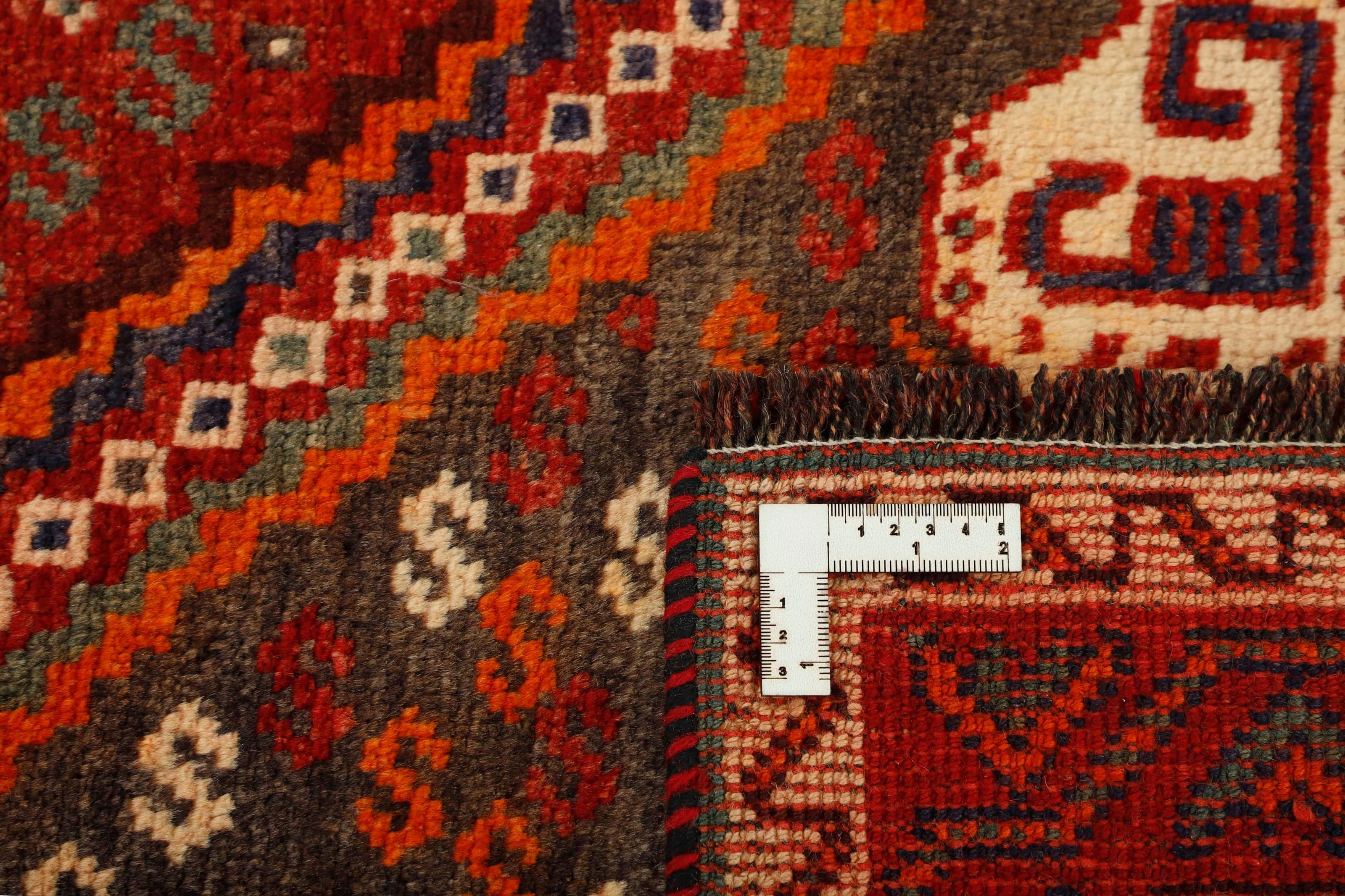 Authentic persian rug with a traditional tribal geometric pattern in red