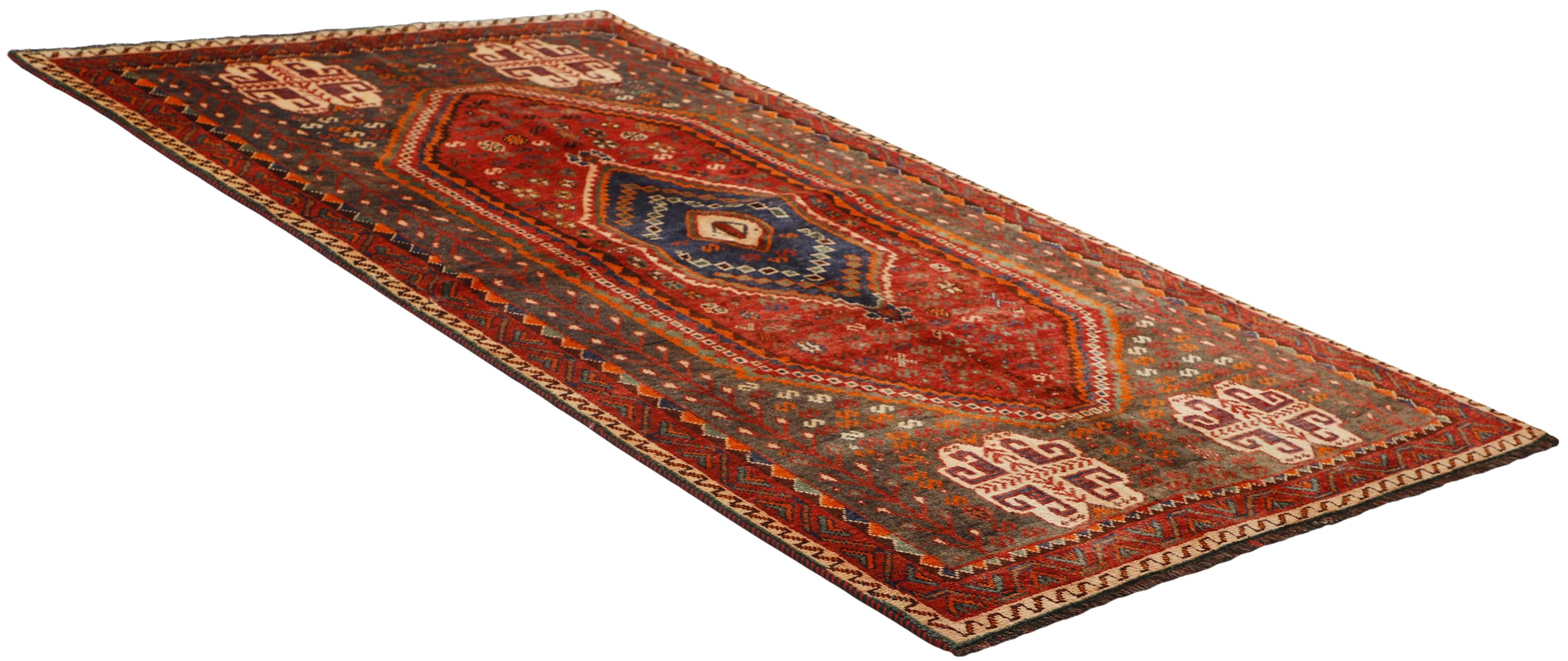 Authentic persian rug with a traditional tribal geometric pattern in red