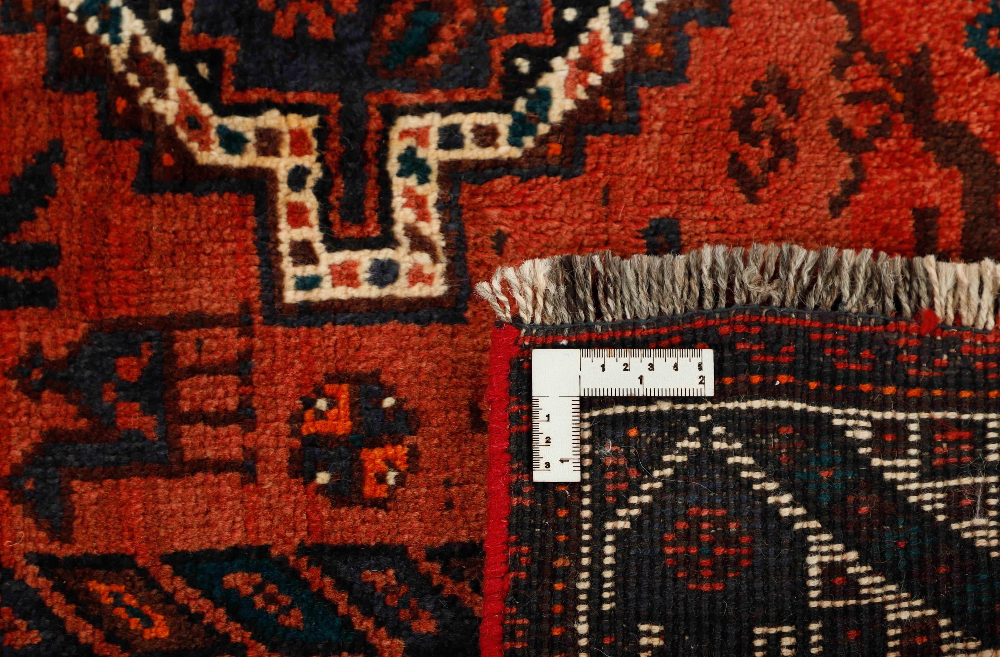Authentic persian rug with a traditional tribal geometric pattern in red