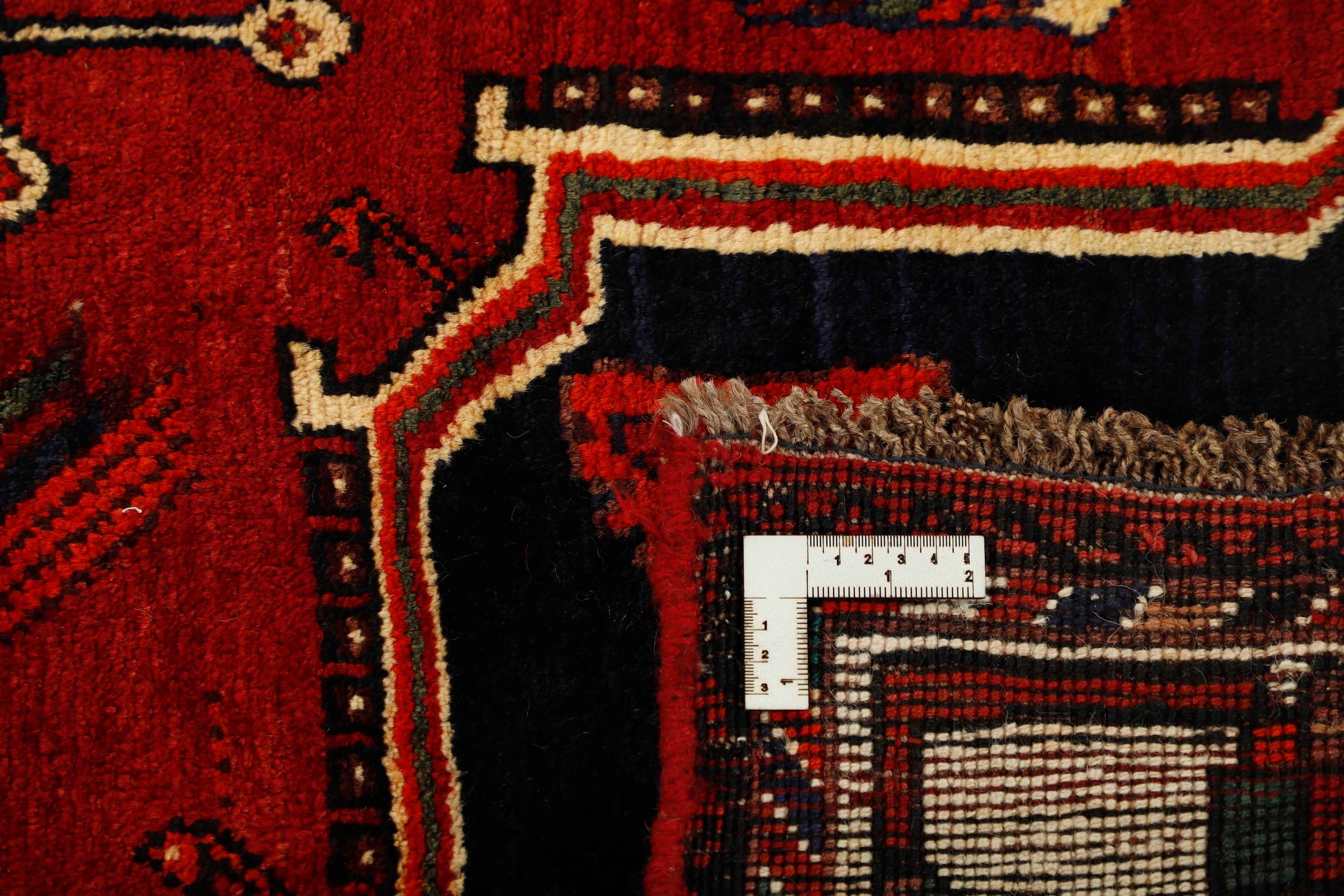 Authentic persian rug with a traditional tribal geometric pattern in red