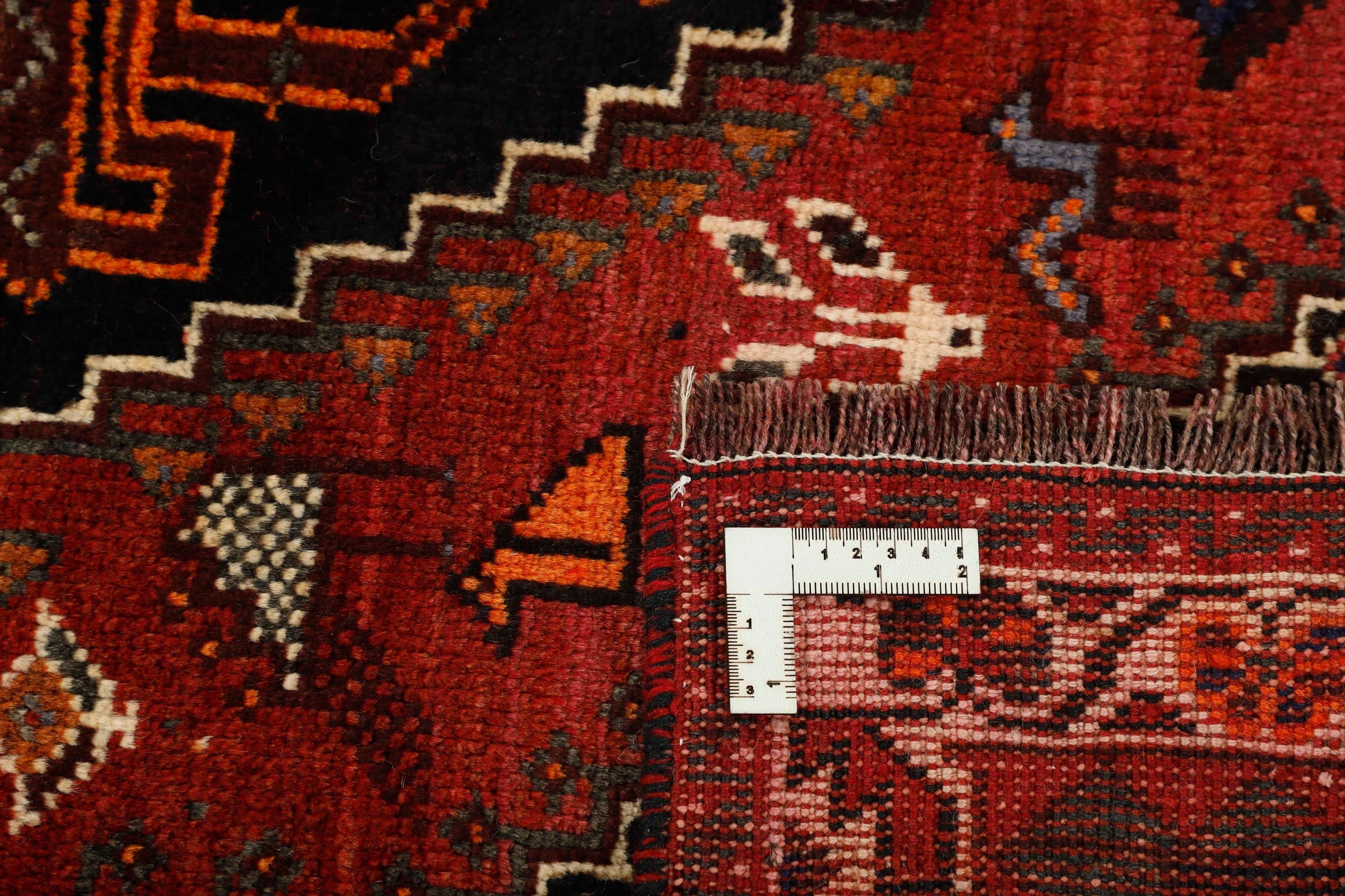 Authentic persian rug with a traditional tribal geometric pattern in red