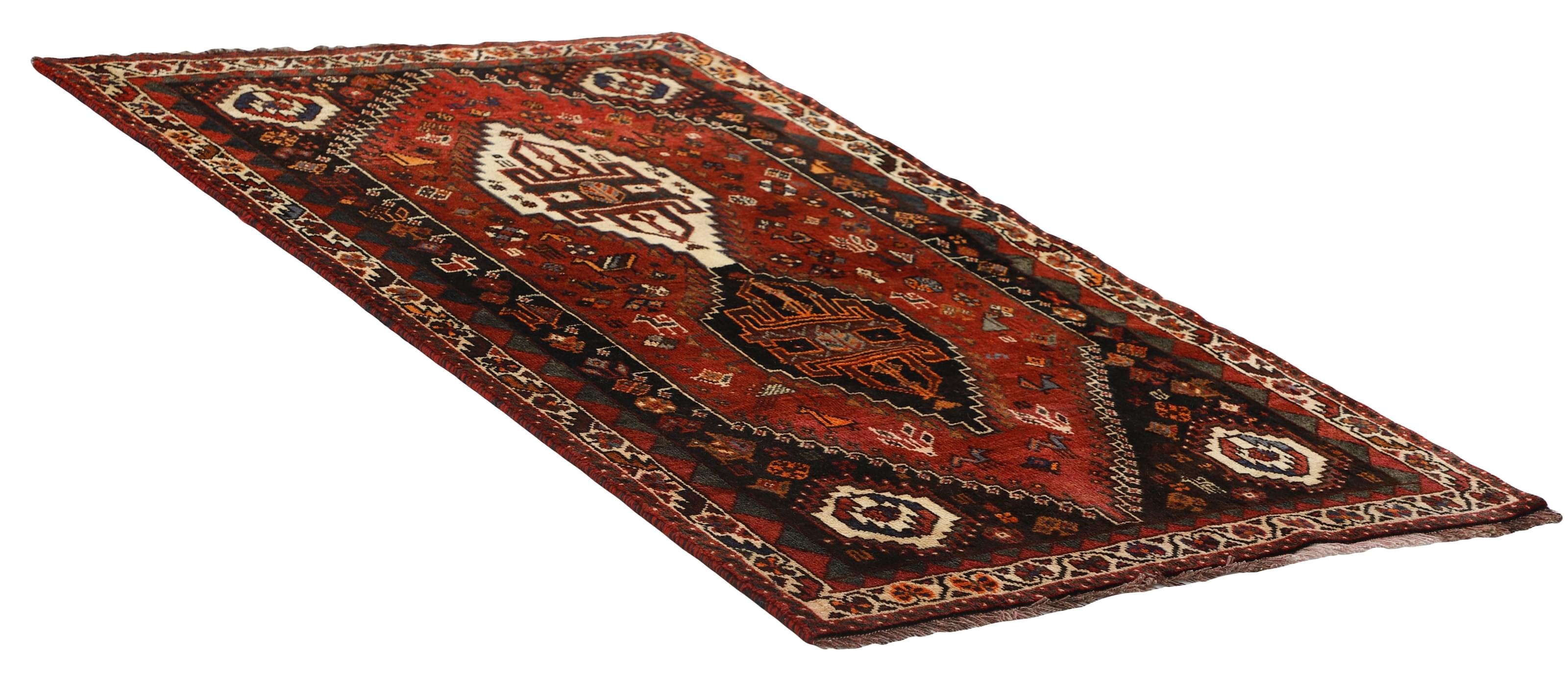 Authentic persian rug with a traditional tribal geometric pattern in red
