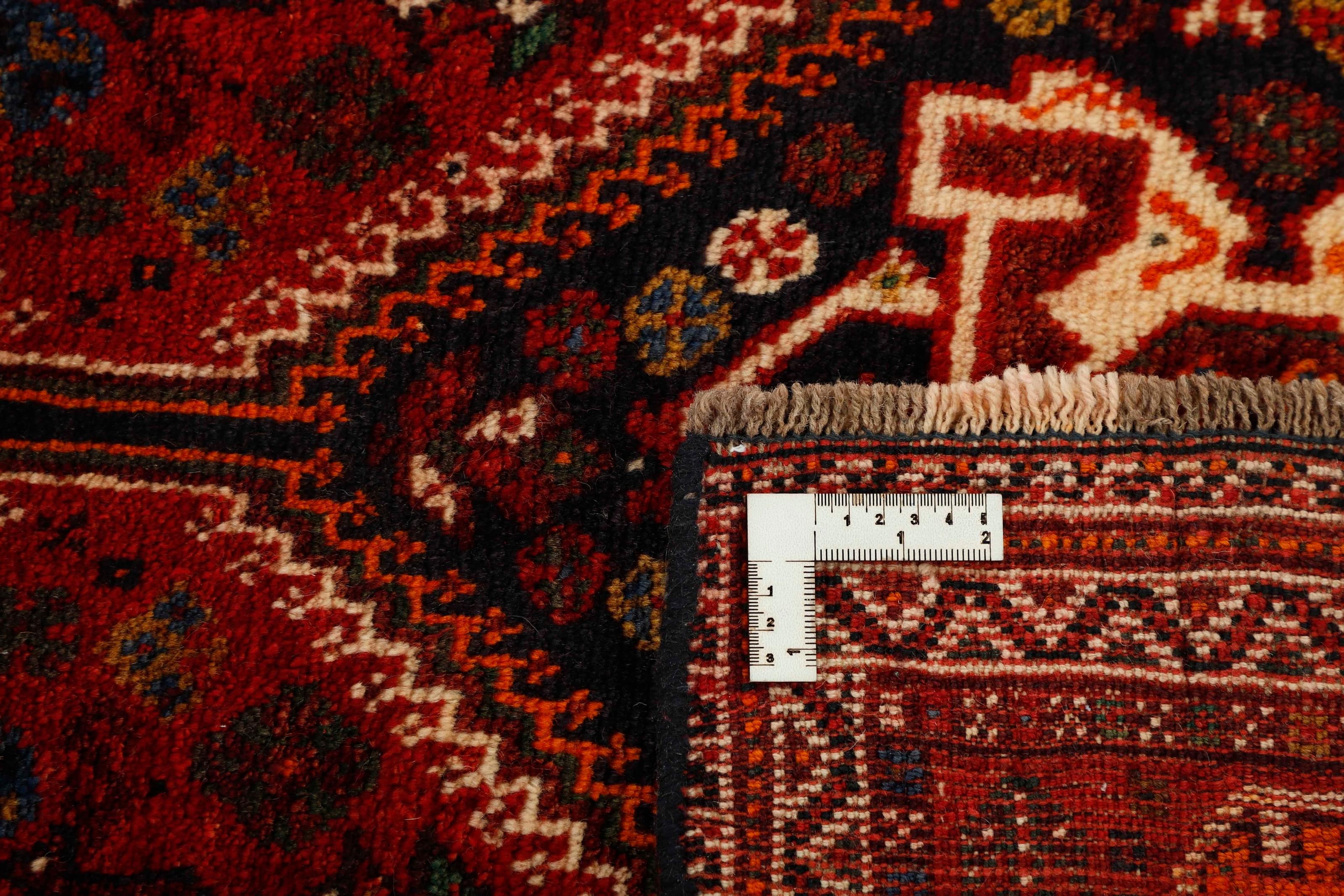 Authentic persian rug with a traditional tribal geometric pattern in red