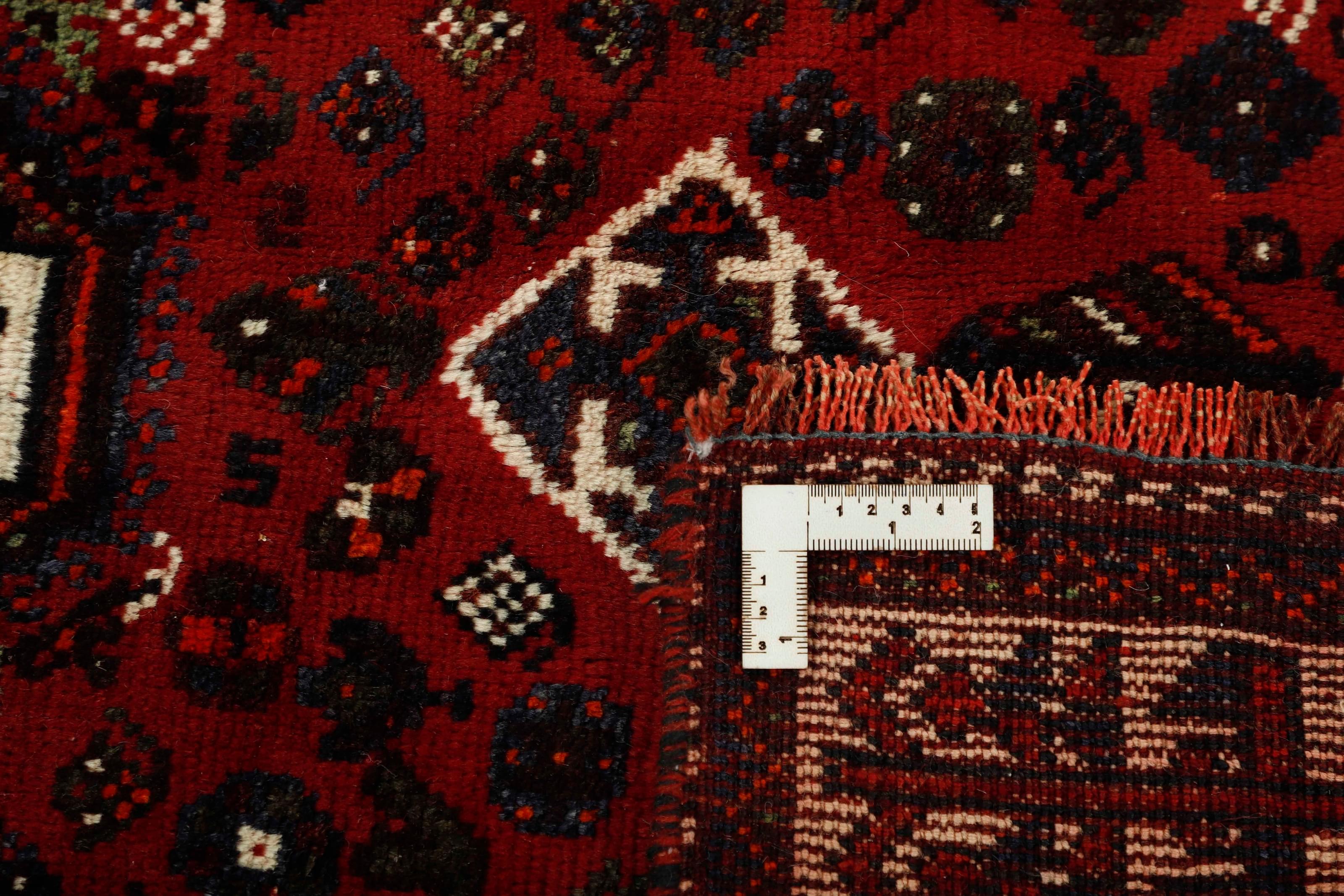 Authentic persian rug with a traditional tribal geometric pattern in red