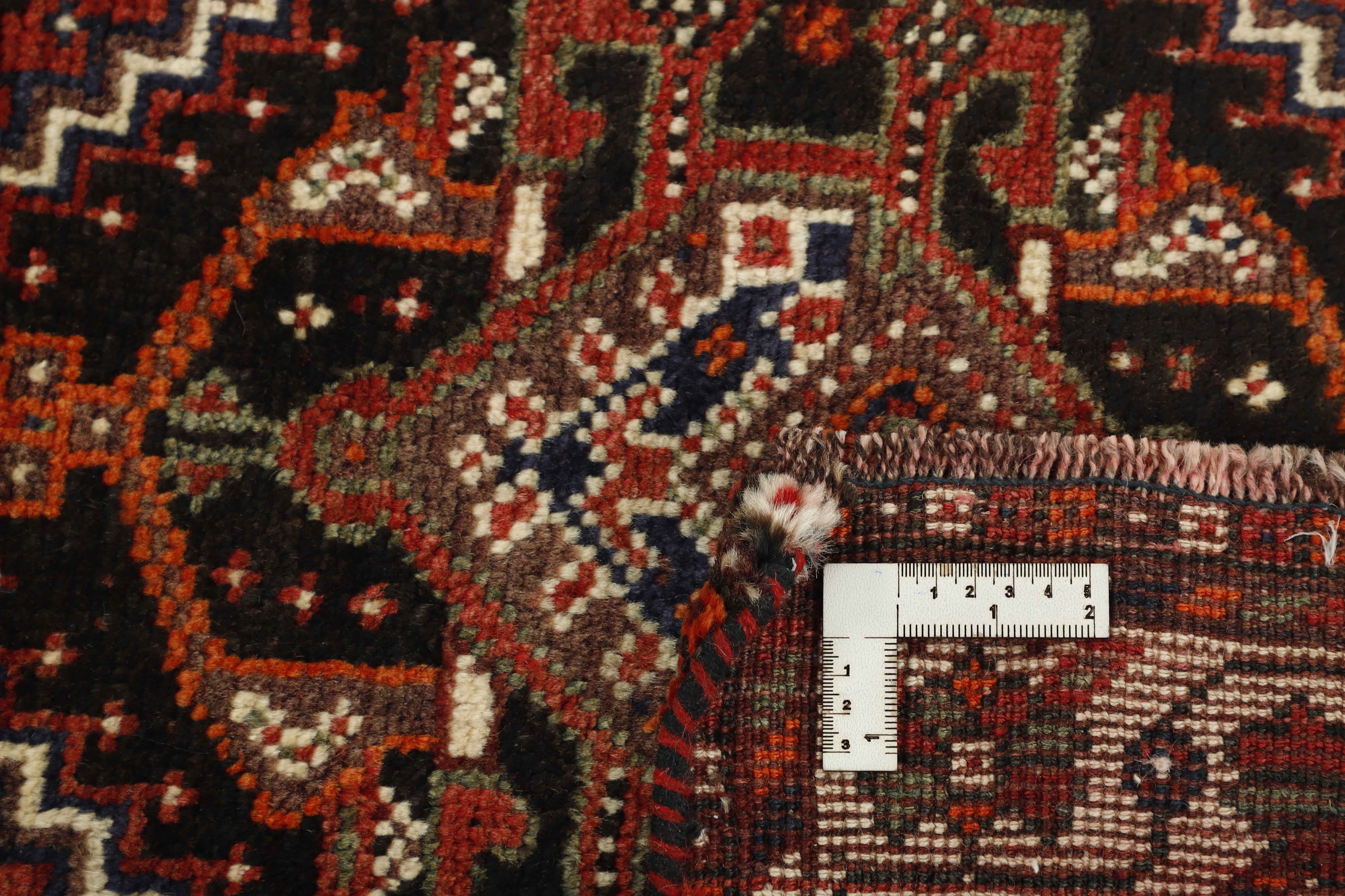 Authentic persian rug with a traditional tribal geometric pattern in red