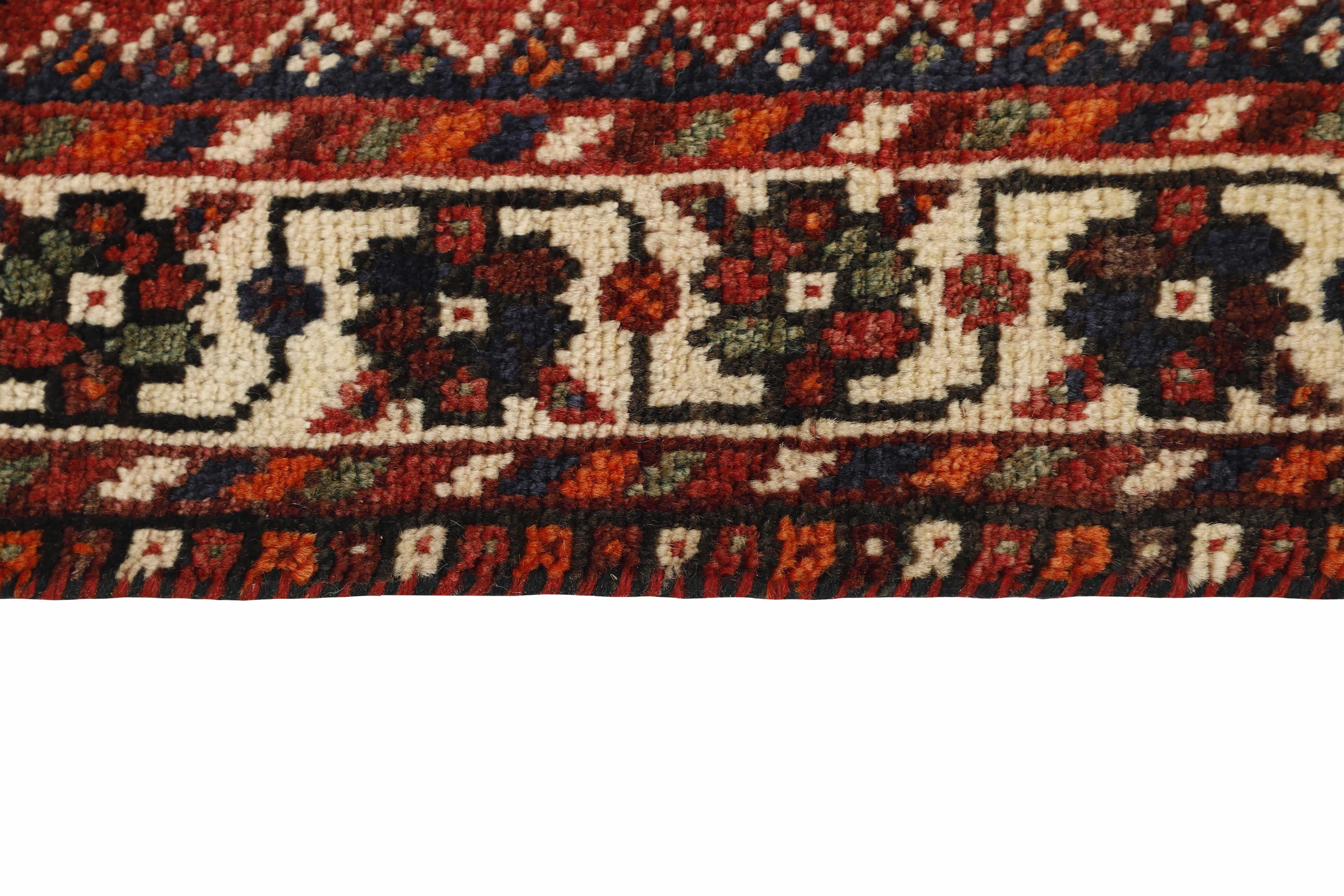 Authentic persian rug with a traditional tribal geometric pattern in red