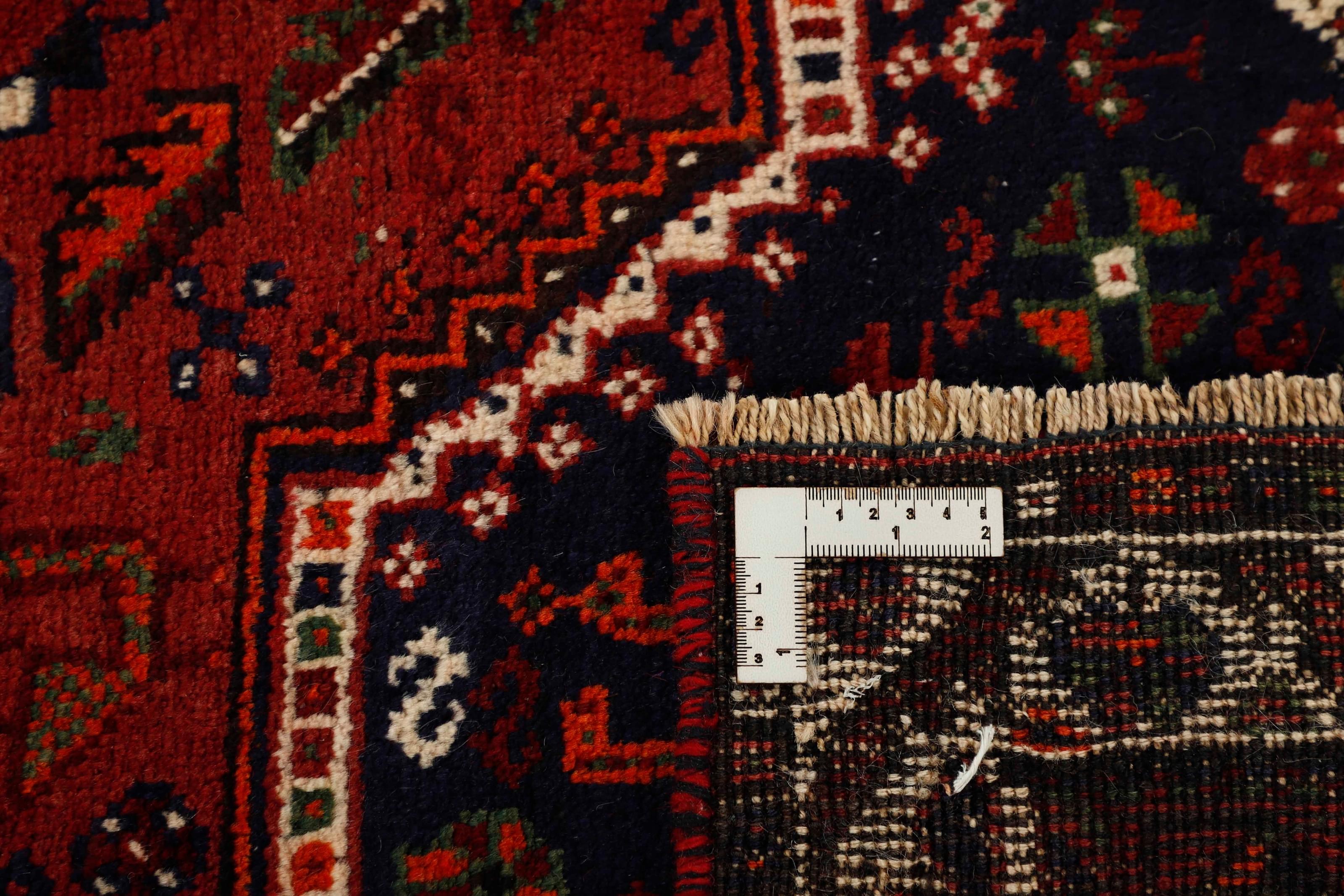 Authentic persian rug with a traditional tribal geometric pattern in red