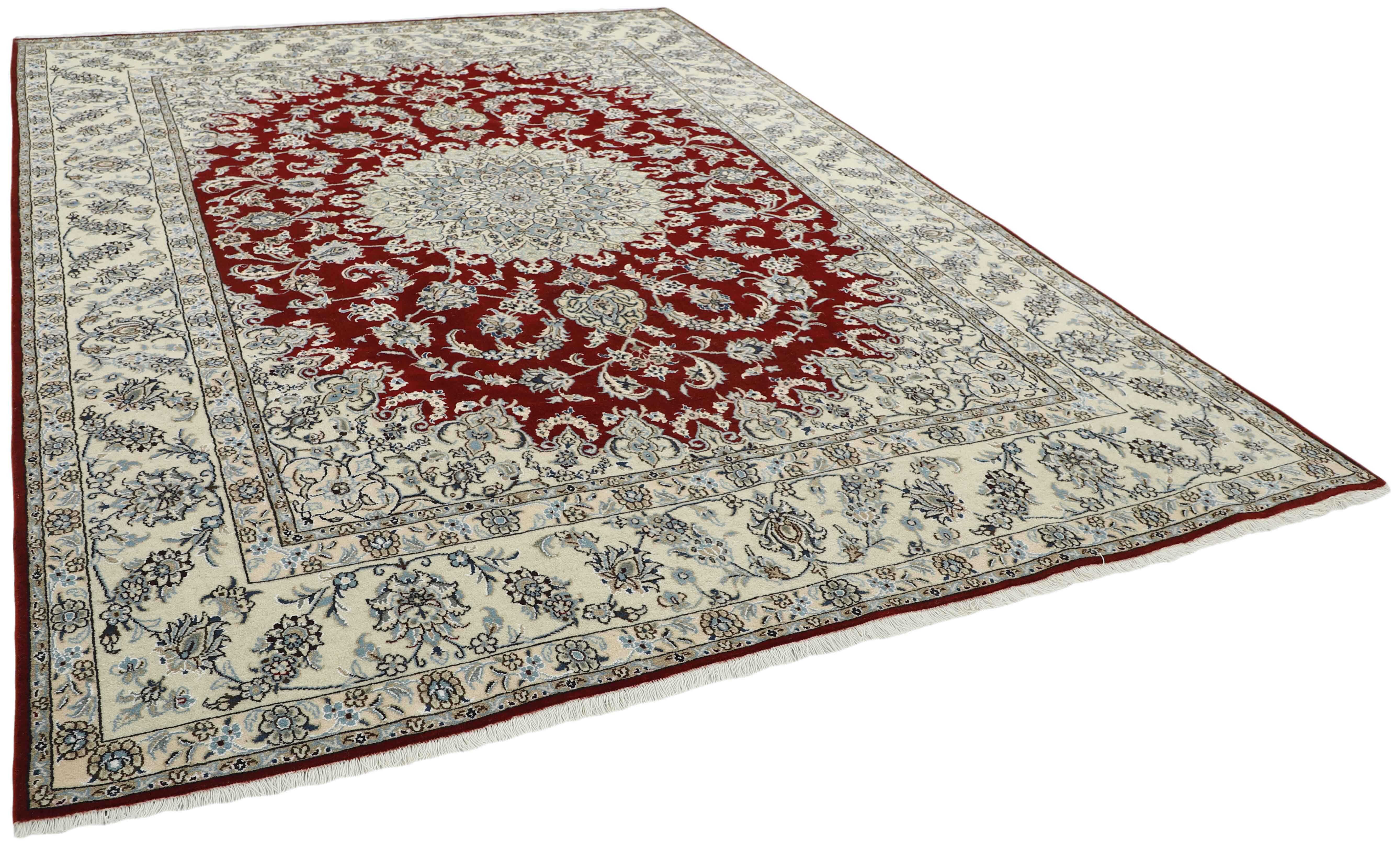 Authentic persian rug with a traditional floral design in beige and red