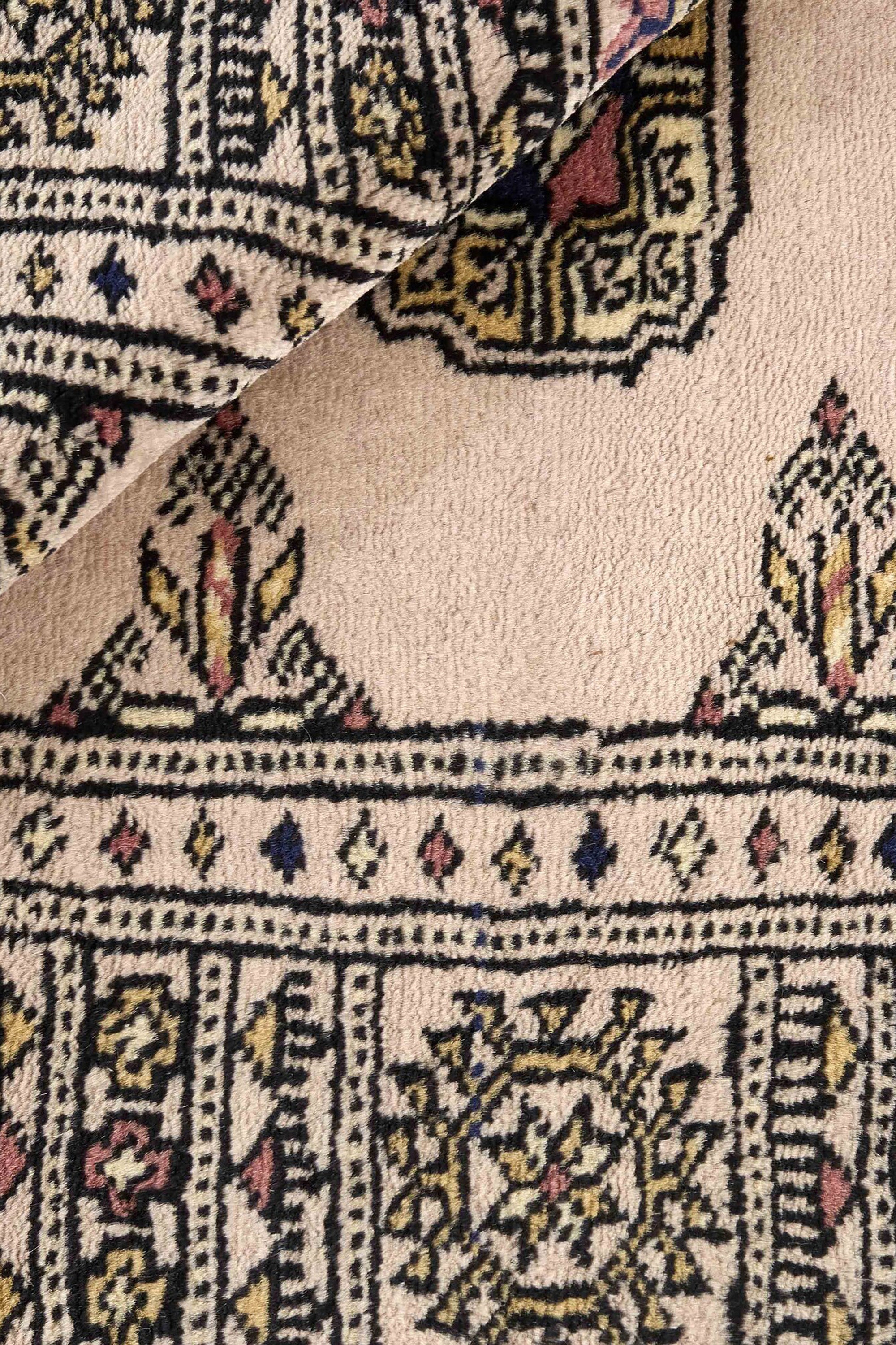 Beige Oriental rug with traditional bordered pattern