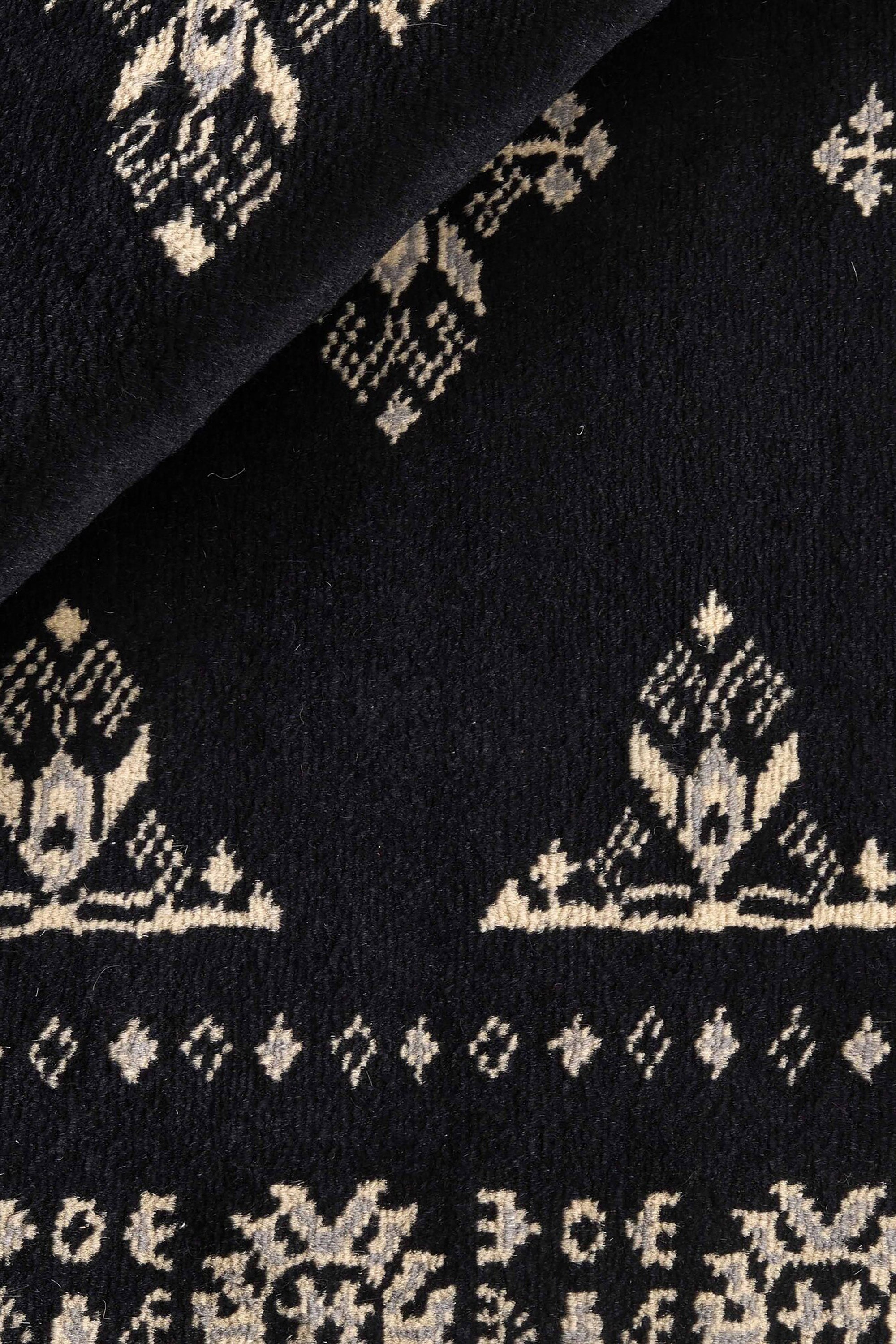 Black Oriental rug with traditional bordered pattern