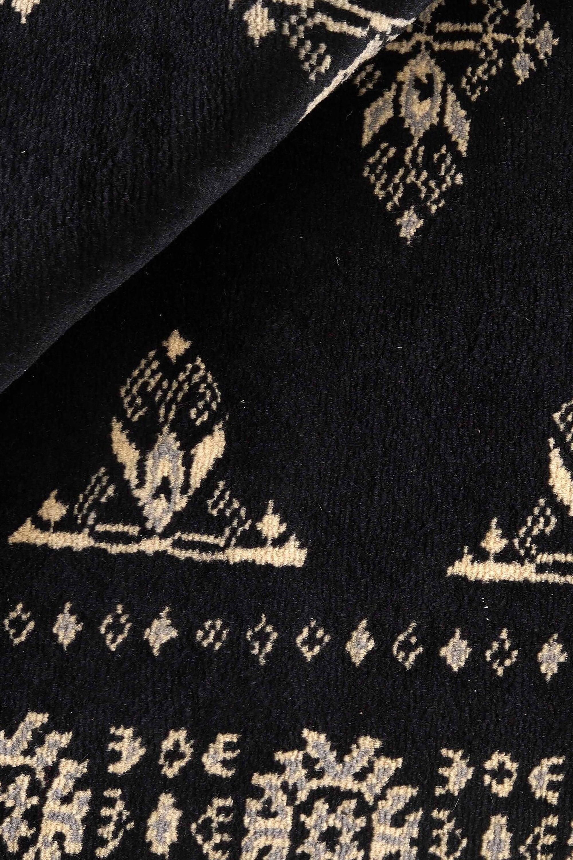 Black Oriental rug with traditional bordered pattern