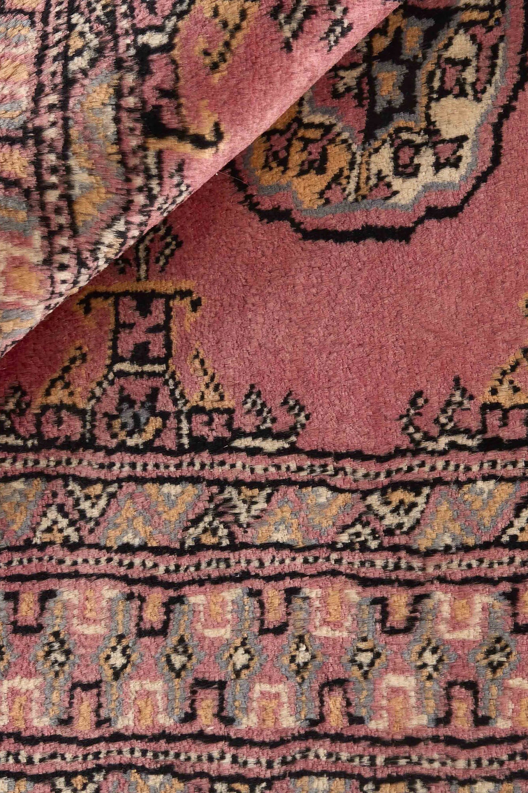 Red Oriental rug with traditional bordered pattern