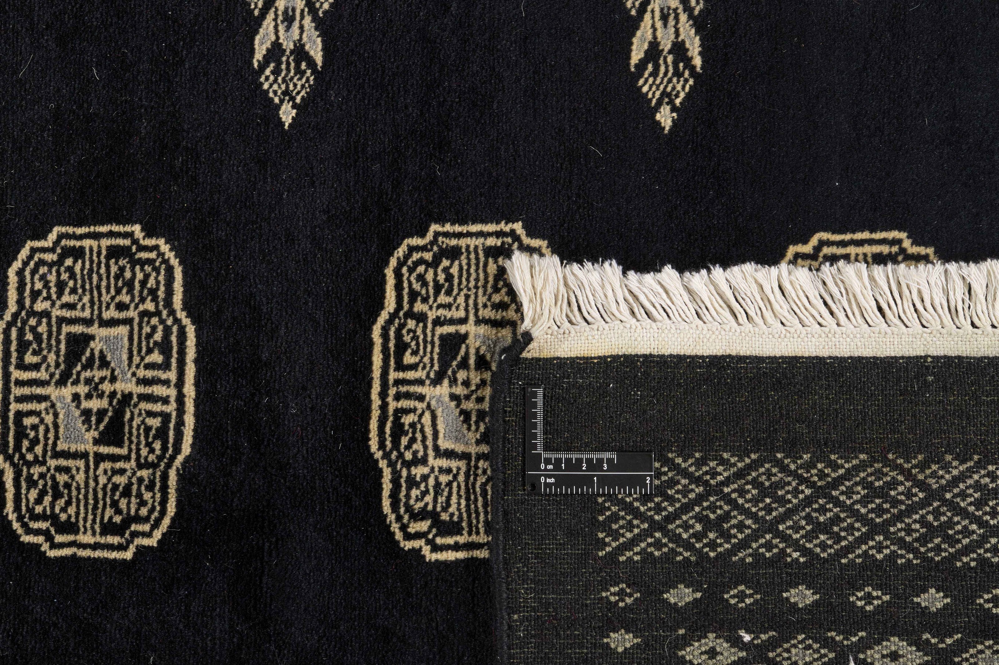Black Oriental rug with traditional bordered pattern