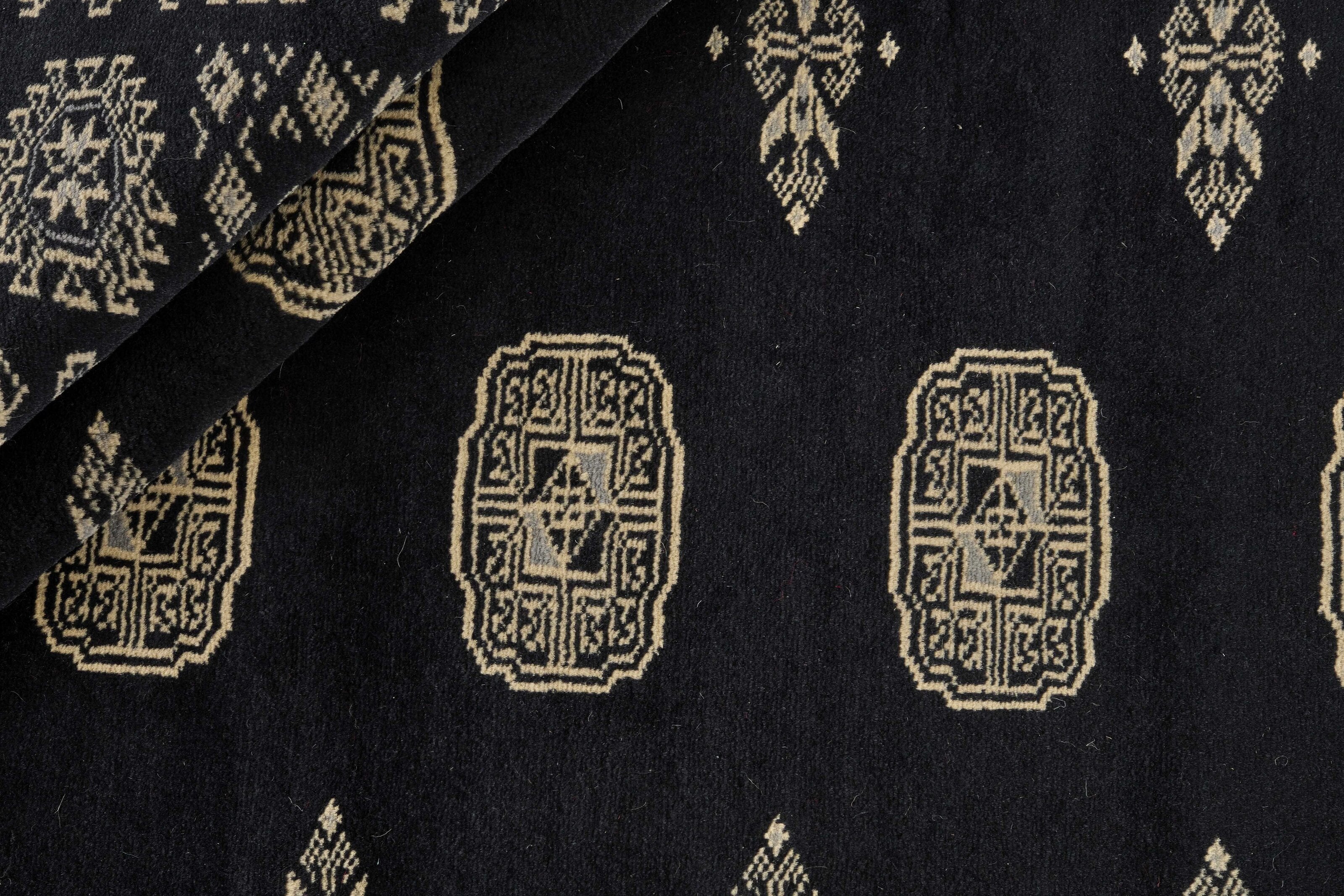 Black Oriental rug with traditional bordered pattern