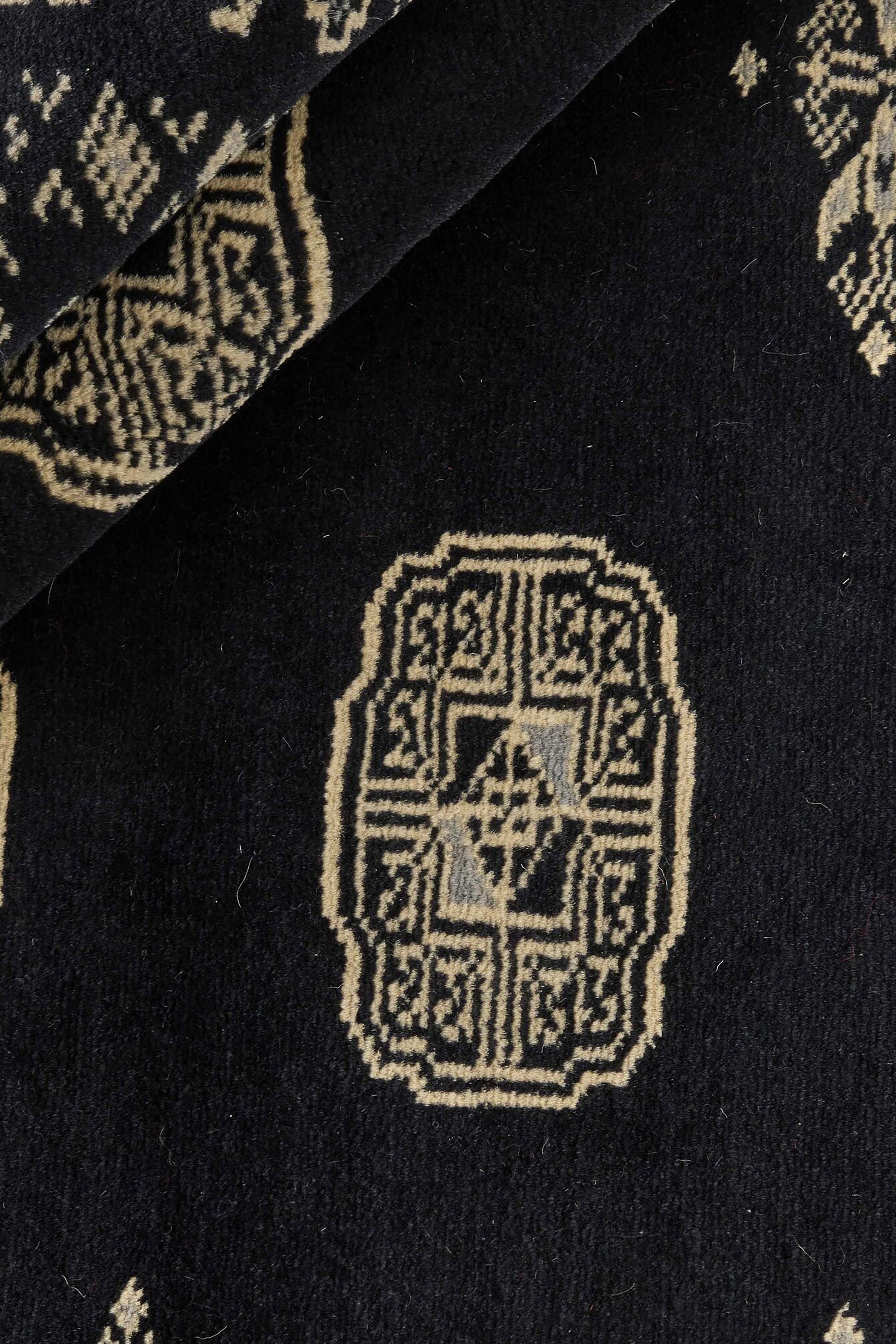 Black Oriental rug with traditional bordered pattern