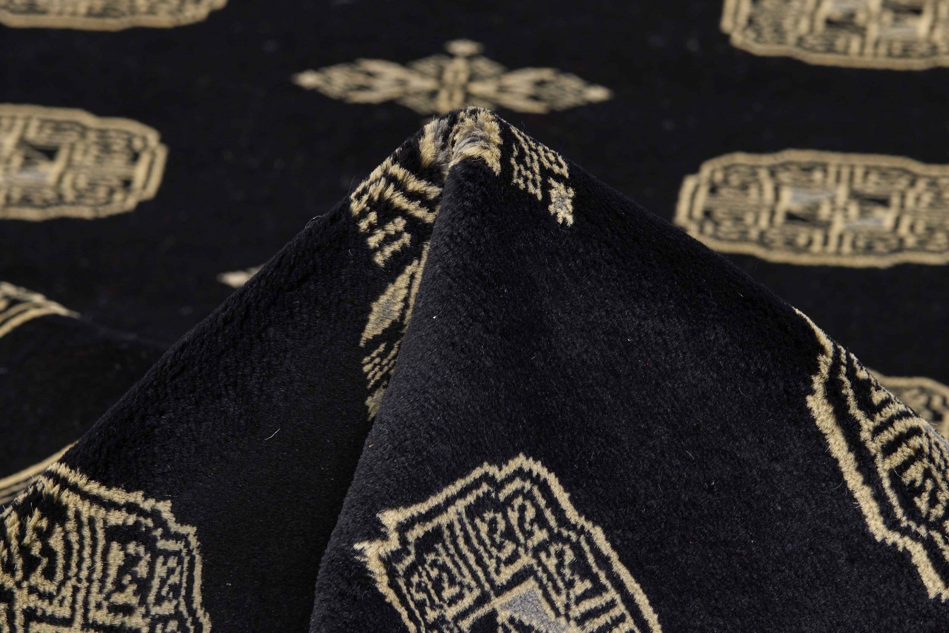 Black Oriental rug with traditional bordered pattern