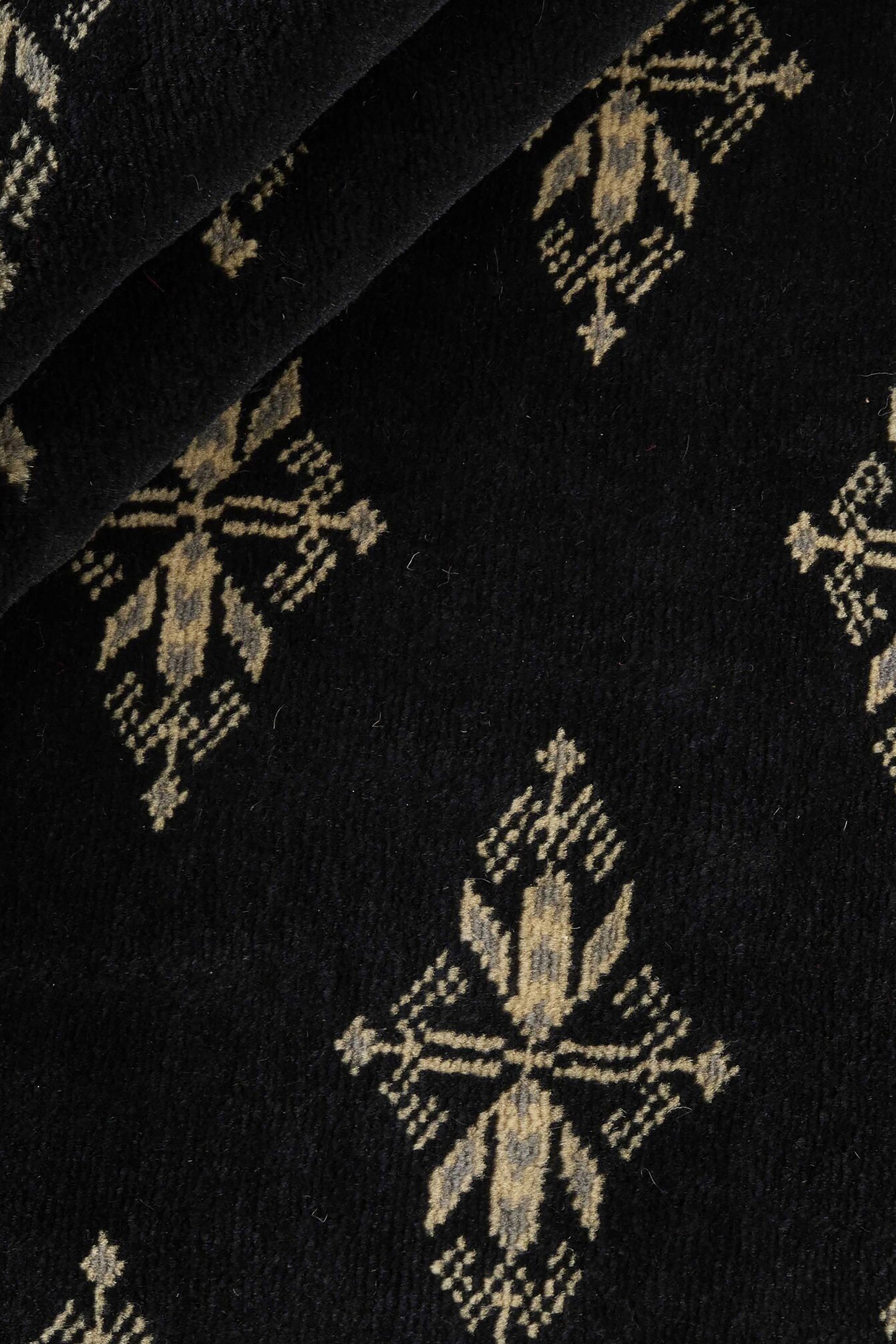 Black Oriental rug with traditional bordered pattern