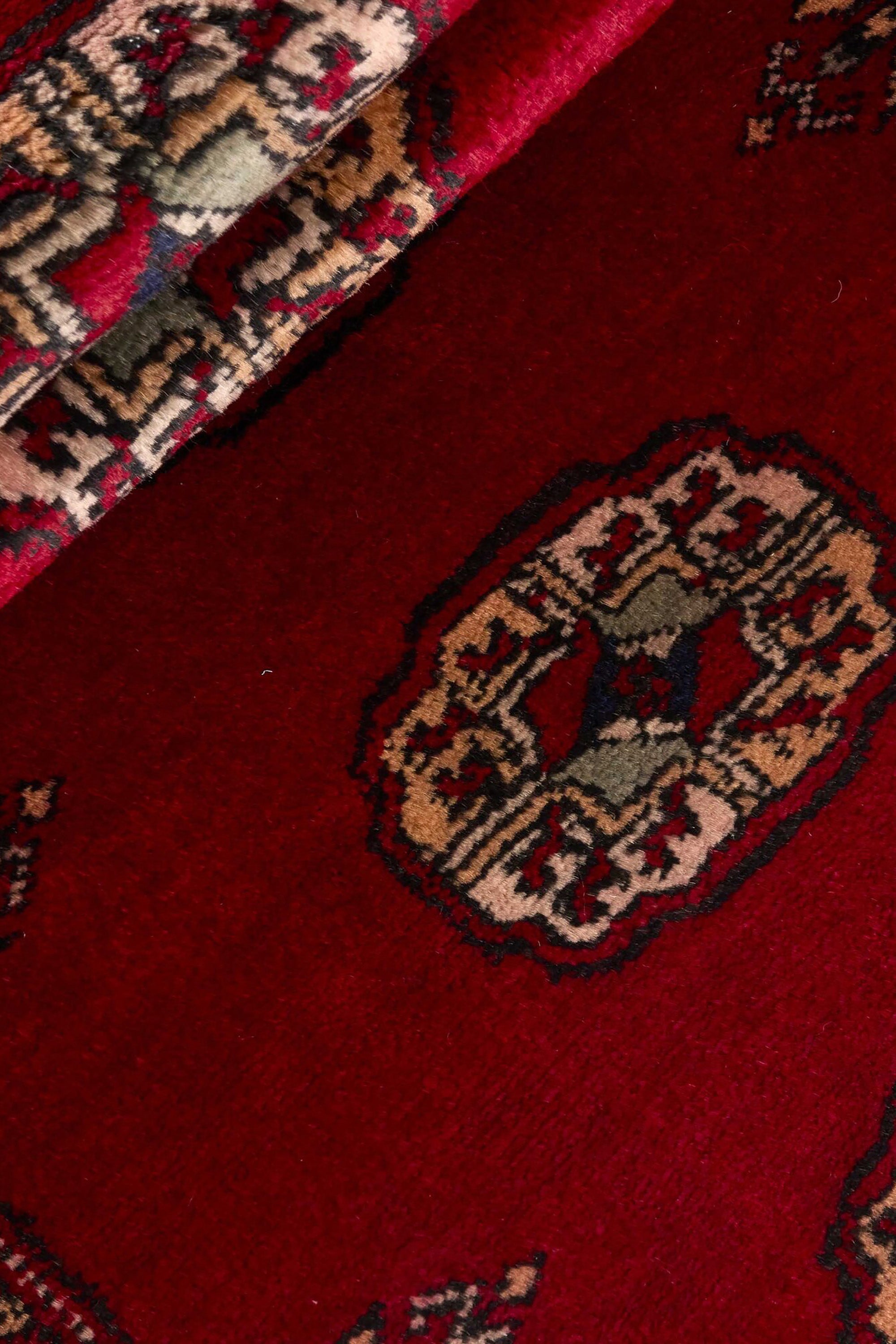 Red Oriental runner with traditional bordered pattern