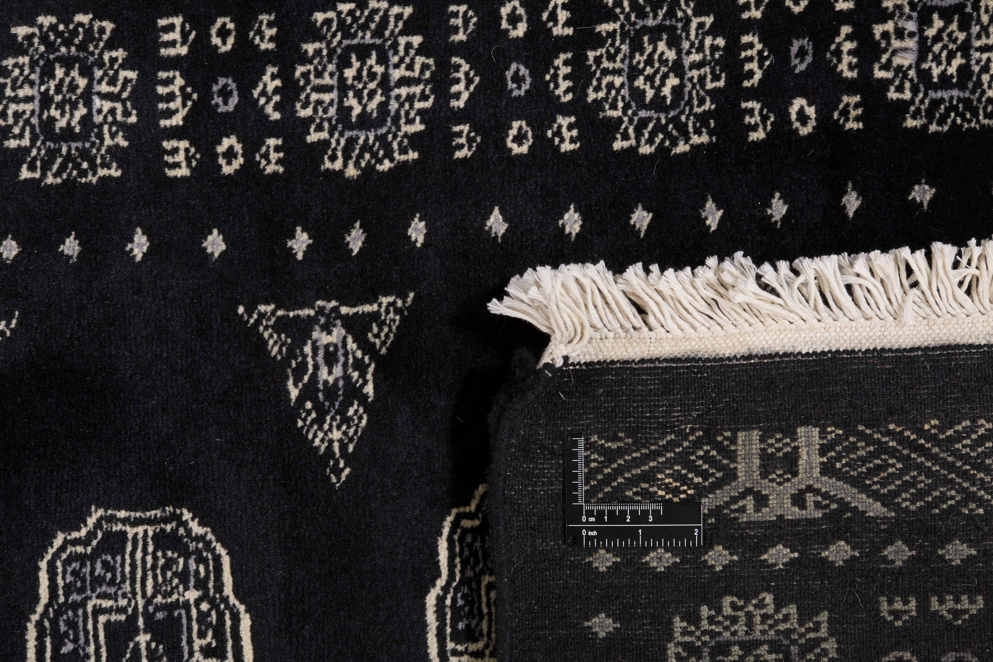 Black Oriental runner with traditional bordered pattern