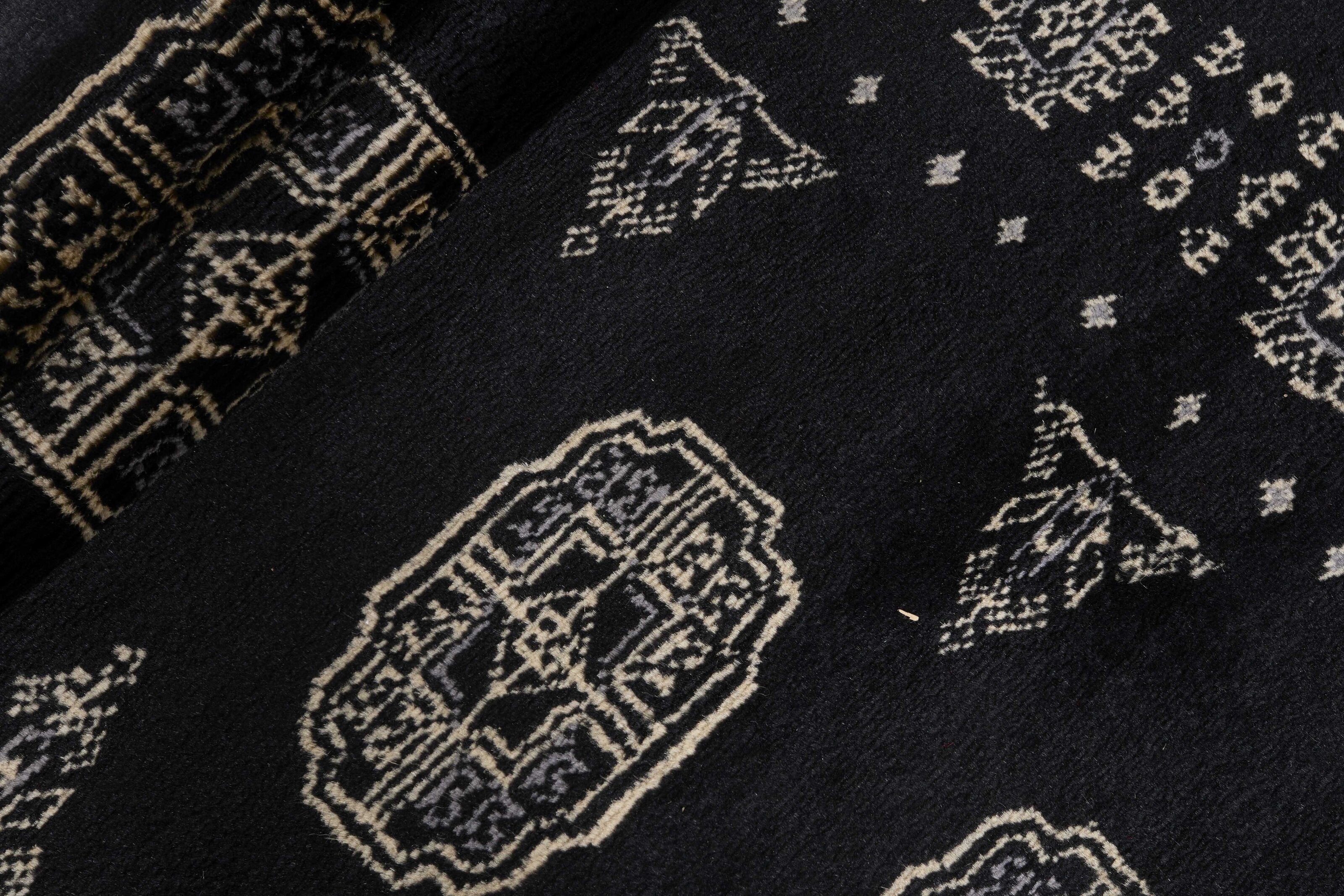 Black Oriental runner with traditional bordered pattern