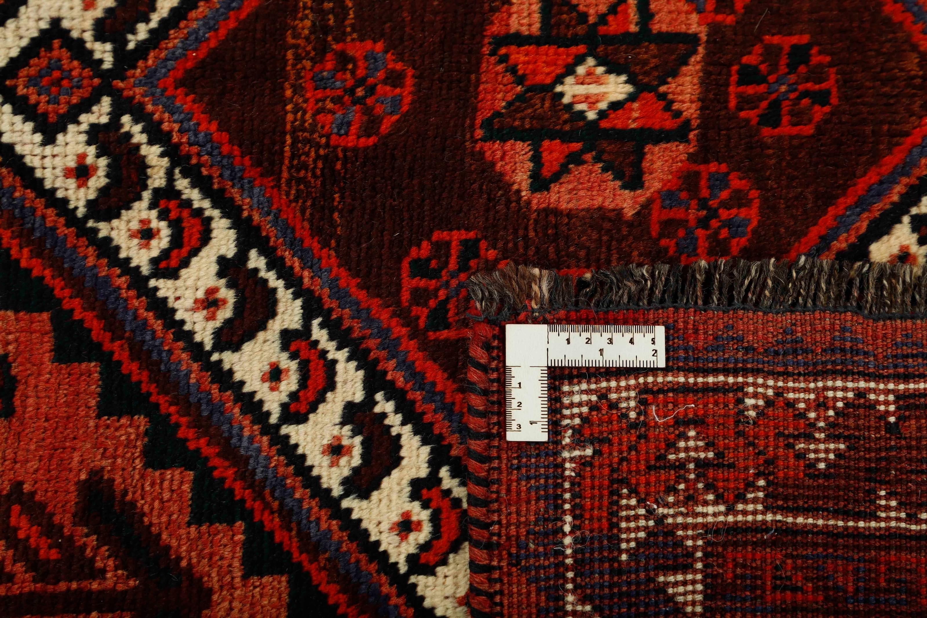 Authentic persian rug with a traditional tribal geometric pattern in red