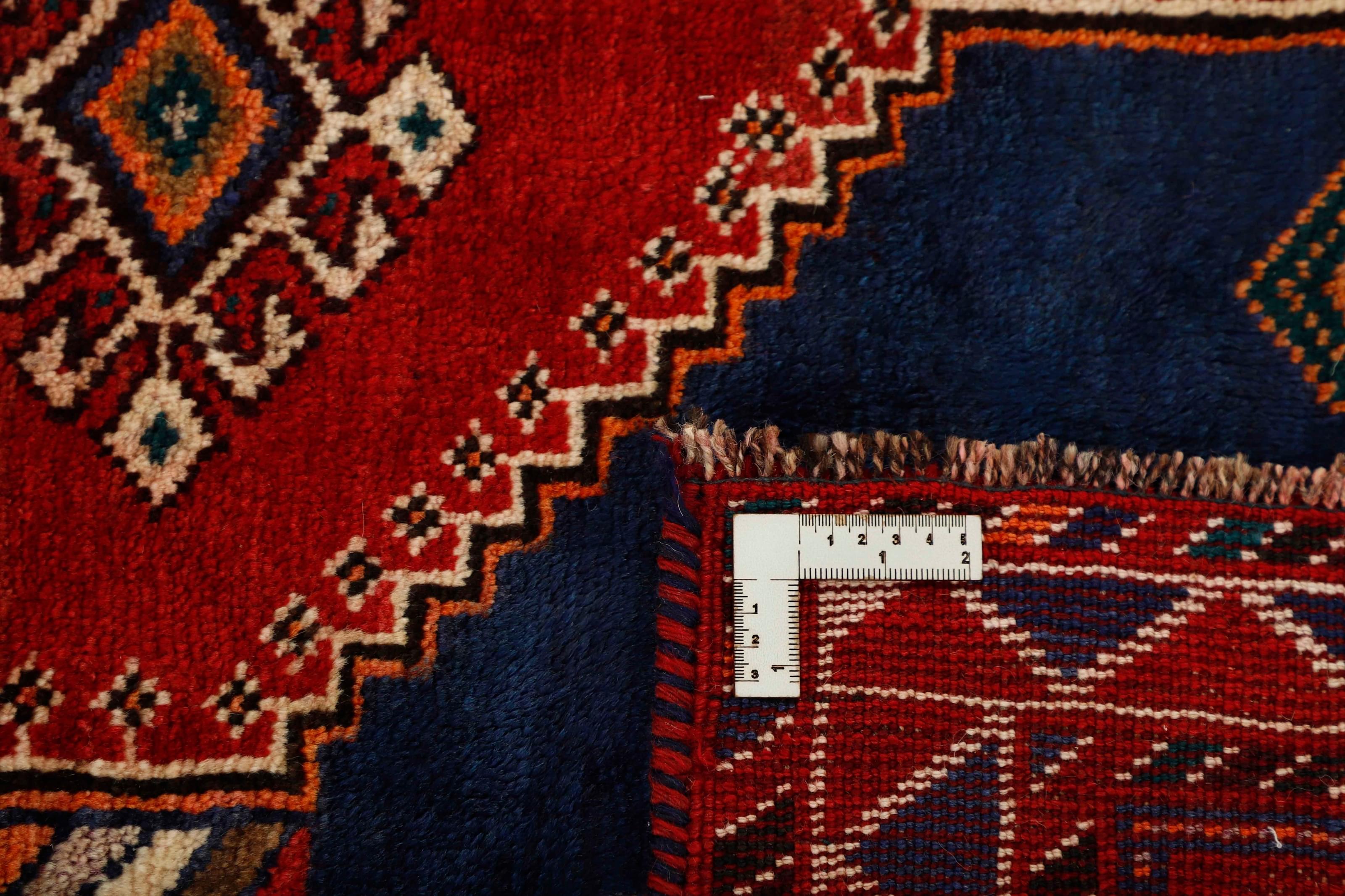 Authentic persian rug with a traditional tribal geometric pattern in red