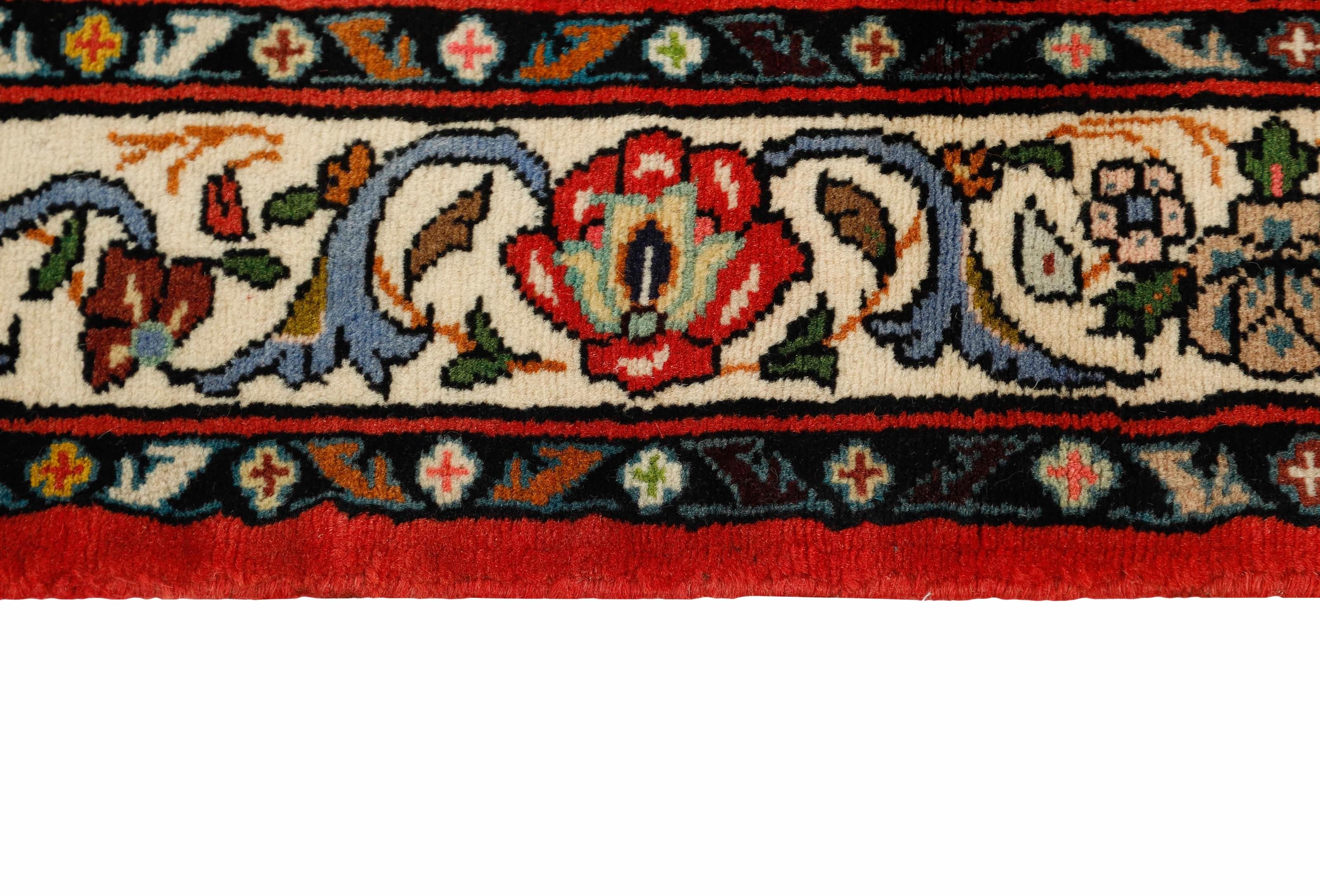 Red and black traditional persian rug with floral design