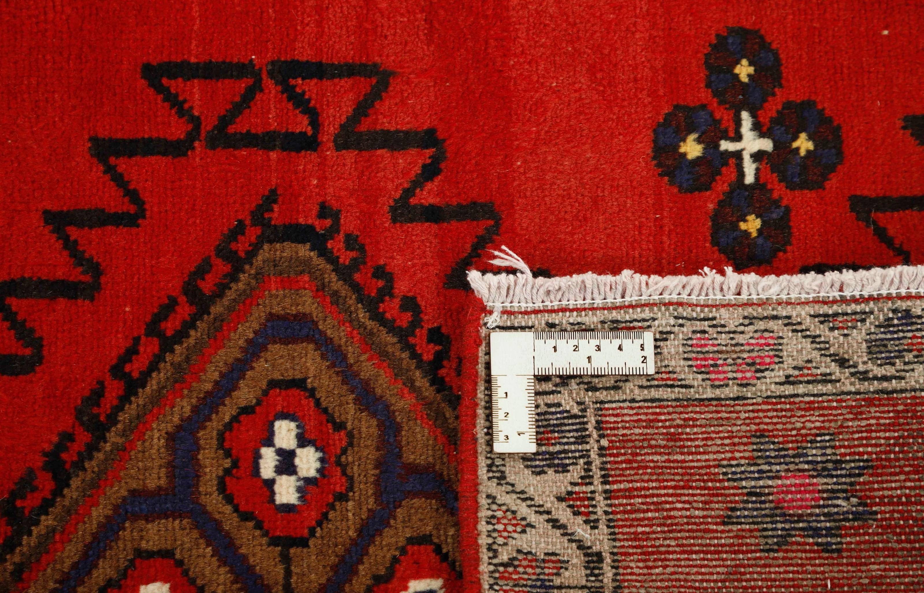 Red and black traditional persian runner with floral design