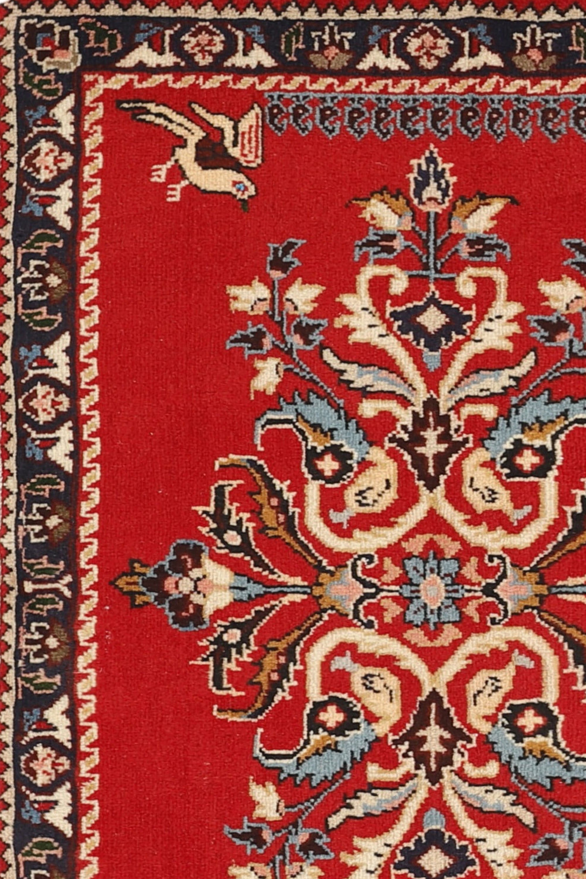 Traditional bordered Keshan rug with red background