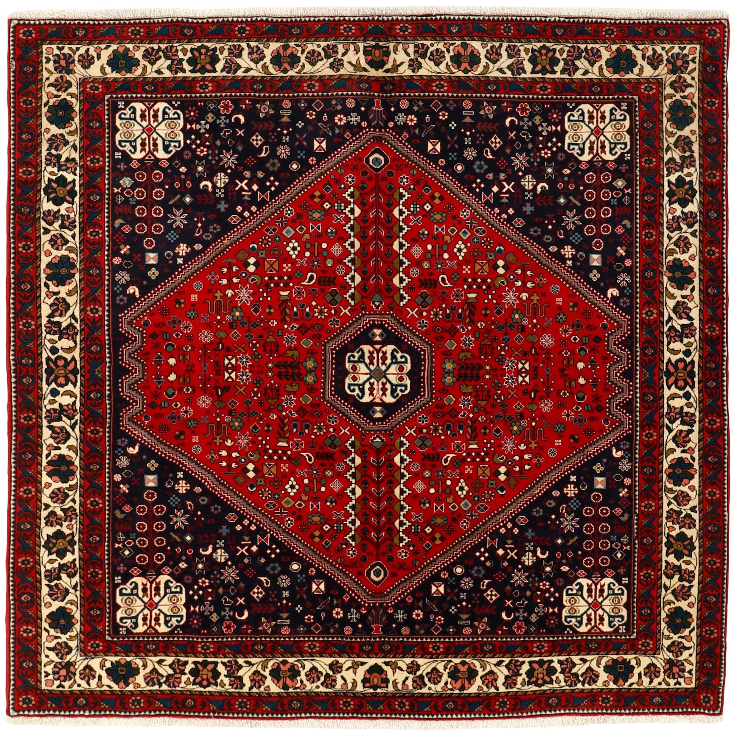 Authentic persian square rug with traditional tribal geometric design in red