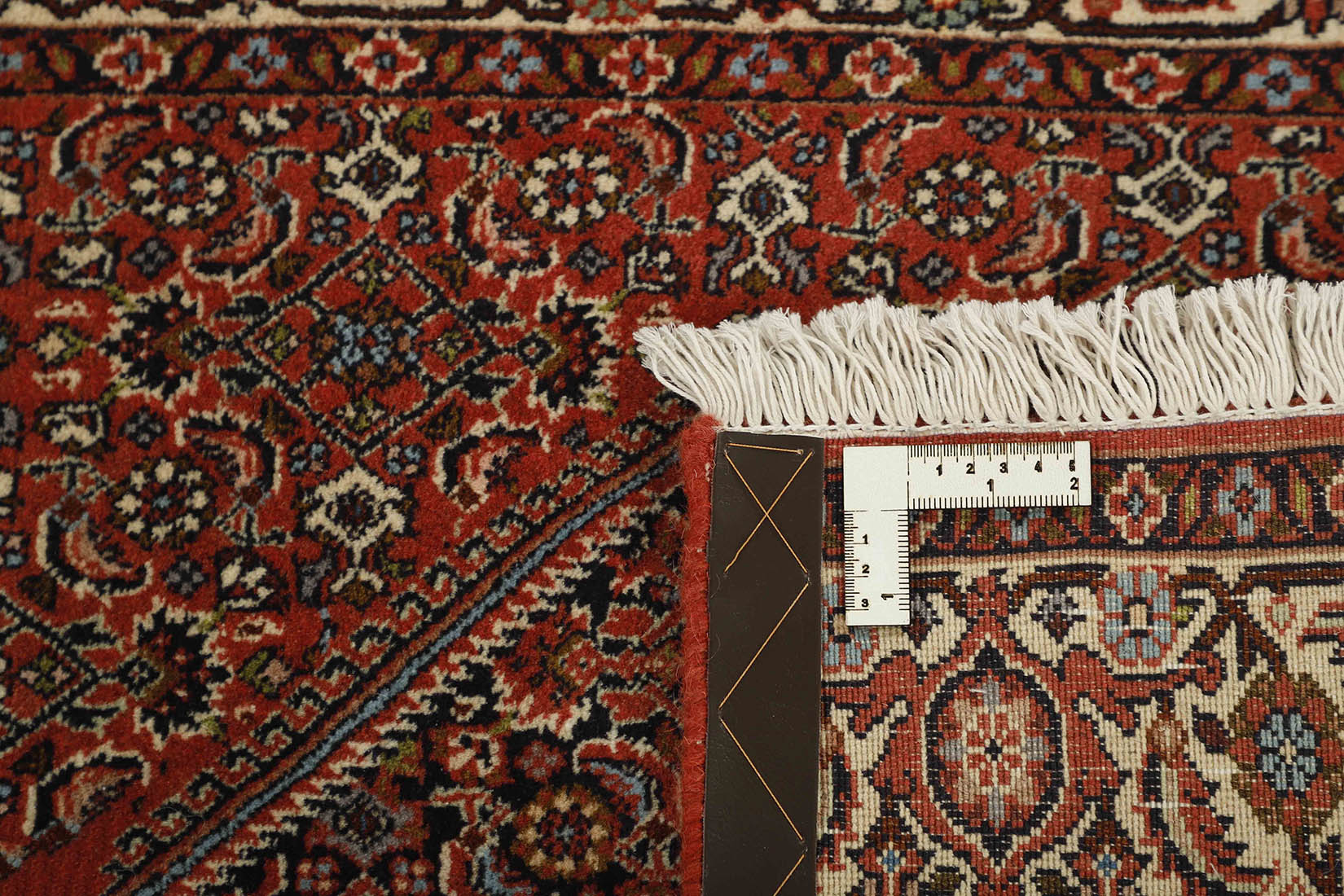 Red and cream persian runner with traditional floral design
